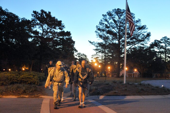 Lt. Gen. Robert Allardice, right, and Tech. Sgt. Raymond Pomeroy, left, lead members of the 437th Airlift Wing and the explosive ordnance disposal team on a 1.5 mile ruck pack march around McCombs Way here Dec. 1. General Allardice stopped at Charleston AFB for a two-day visit as part of his tour of the bases within his command. General Allardice is the 18th Air Force commander and Sergeant Pomeroy is the EOD superintendent assigned to the 437th Civil Engineer Squadron. (U.S. Air Force photo/Staff Sgt. Marie Brown)