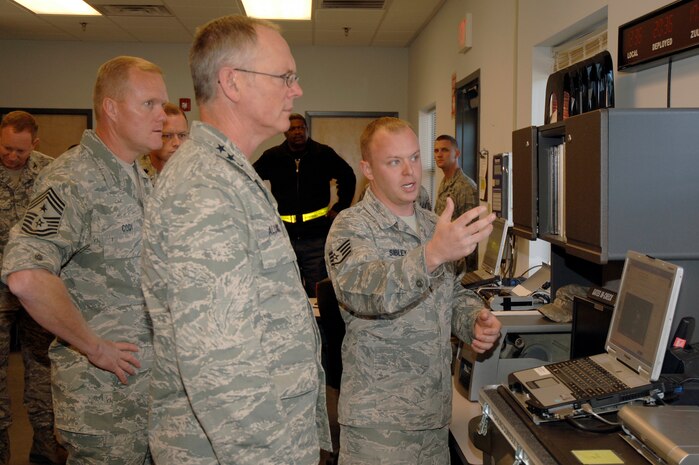 Lt. Gen. Robert Allardice, center, and Chief Master Sgt. James Cody, left, watches as Staff Sgt. Michael Sibley, right, demonstrates how a vehicle being shipped out gets weighed prior to being loaded onto an aircraft during a tour of the cargo deployment facility here Dec. 1. General Allardice stopped at Charleston AFB for a two-day visit as part of his tour of the bases within his command. General Allardice is the 18th Air Force commander and Chief Cody is the 18th Air Force command chief. Sergeant Sibley is assigned to the 437th Aerial Port Squadron. (U.S. Air Force photo/Staff Sgt. Marie Brown)