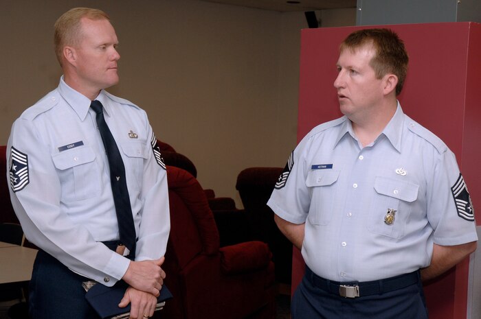 Chief Master Sgt. James Cody speaks with Chief Master Sgt. Denny Heitman at the fire department here Nov. 30. Chief Cody accompanied Lt. Gen. Robert Allardice on a two-day visit to Charleston AFB which included tours and briefings from multiple squadrons here on base. Chief Cody is the 18th Air Force command chief and Chief Heitman is the Fire Chief assigned to the 437th Civil Engineering Squadron. (U.S. Air Force photo/Staff Sgt. Marie Brown)