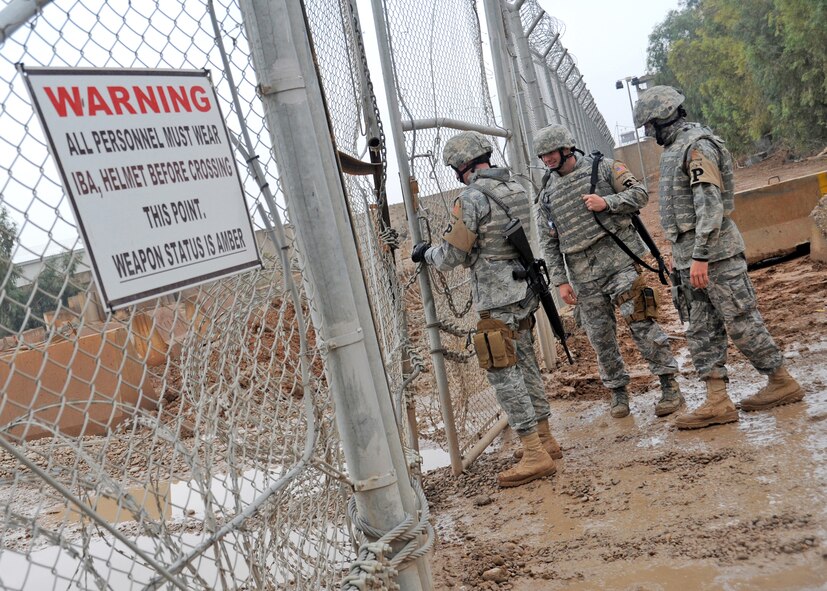 332nd Expeditionary Civil Engineer force protection escorts prepare to conduct a sweep for contraband items left by local nationals at the gravel yard Nov. 19, 2009 at Joint Base Balad, Iraq. Airmen deployed as FP escorts protect resources while providing safety and security on JBB. (U.S. Air Force photo/Senior Airman Christopher Hubenthal)
