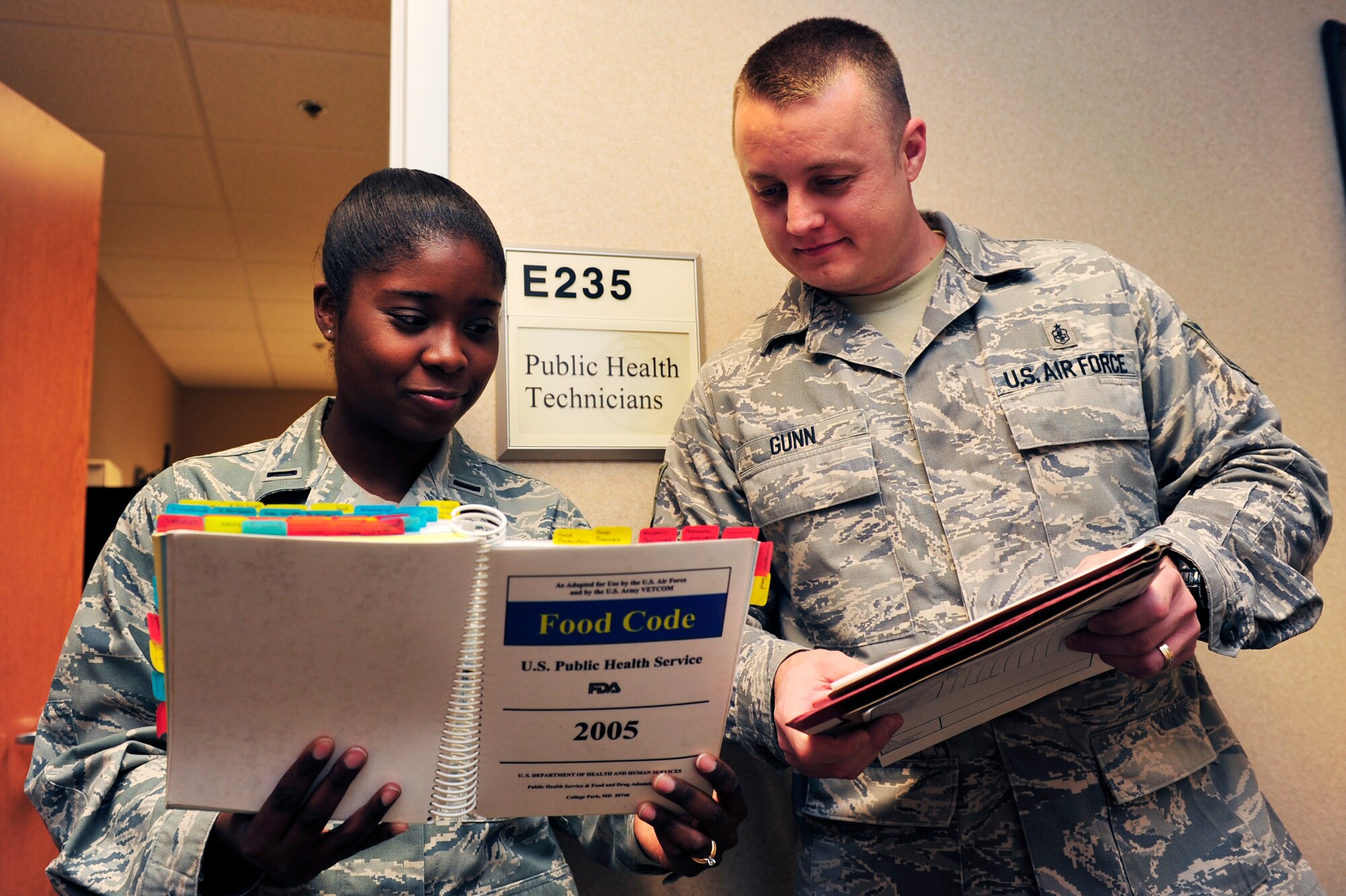 1st Lt. Jessica Le, 19th Medical Group deputy flight commander, and Tech. Sgt. Timothy Gunn, 19th MDG NCO-in-charge of force health management, use food code as guidance when reviewing inspection folders for food facilities. Lieutenant Le oversaw 300 clinic employees’ health programs and maintained a compliance rate at 100 percent. She also educated unit deployment monitors on the Disease Containment Plan for the seasonal flu prevention exercise and vaccinated 2,700 people in 36 hours. (U.S. Air Force photo by Airman 1st Class Lausanne Pacheco)