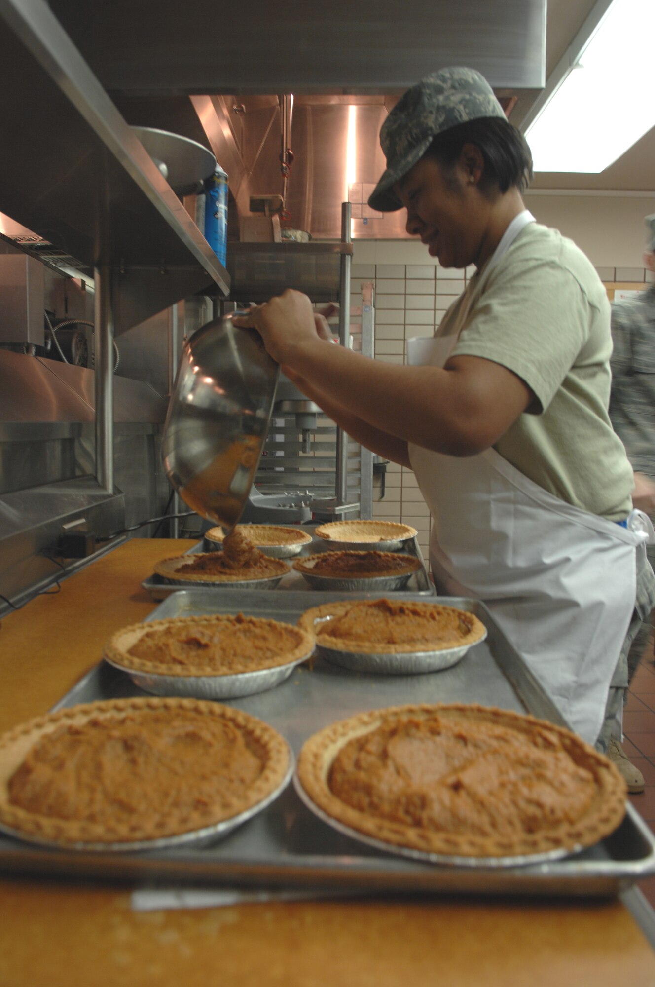 Senior Airman Kimberly Jefferies pours pumpkin pie filling into pie shells Nov. 25, 2009, Eielson Air Force Base, Alaska. The Two Seasons Dining Facility is open 365 days of the year as most Airmen rely on it for everyday meals. Airman Jefferies is assigned to the 354th Force Support Squadron. (U.S. Air Force photo/Airman 1st Class Rachelle Coleman)