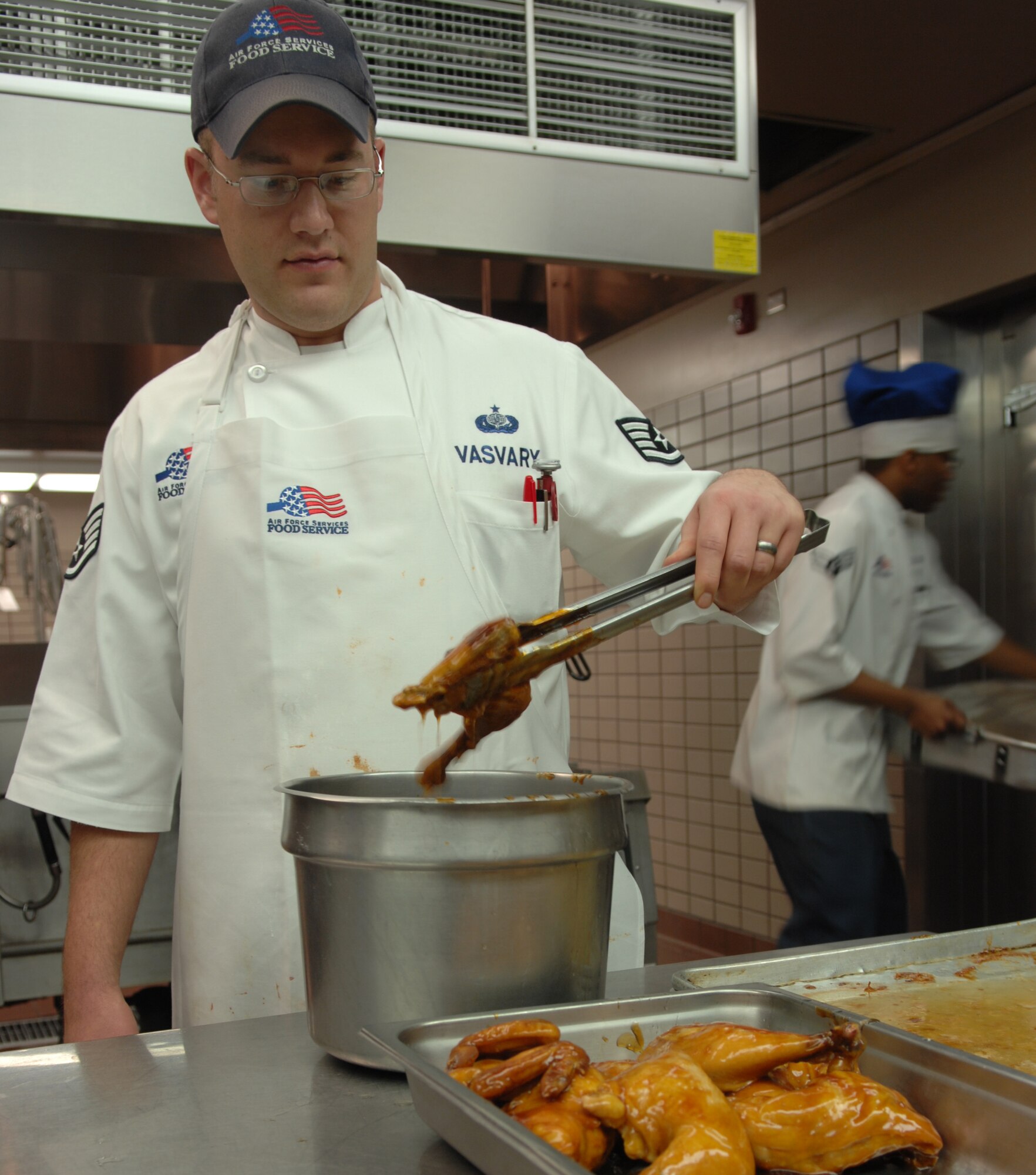 Staff Sgt. Brian Vasvary prepares chicken for dinner at the Two Season Dining Facility Nov. 25, 2009, Eielson Air Force Base, Alaska. Hundreds of Airmen rely on the dining facility for their everyday meals. Sergeant Vasvary is a 354th Force Support Squadron food services shift leader. (U.S. Air Force photo/Airman 1st Class Rachelle Coleman)