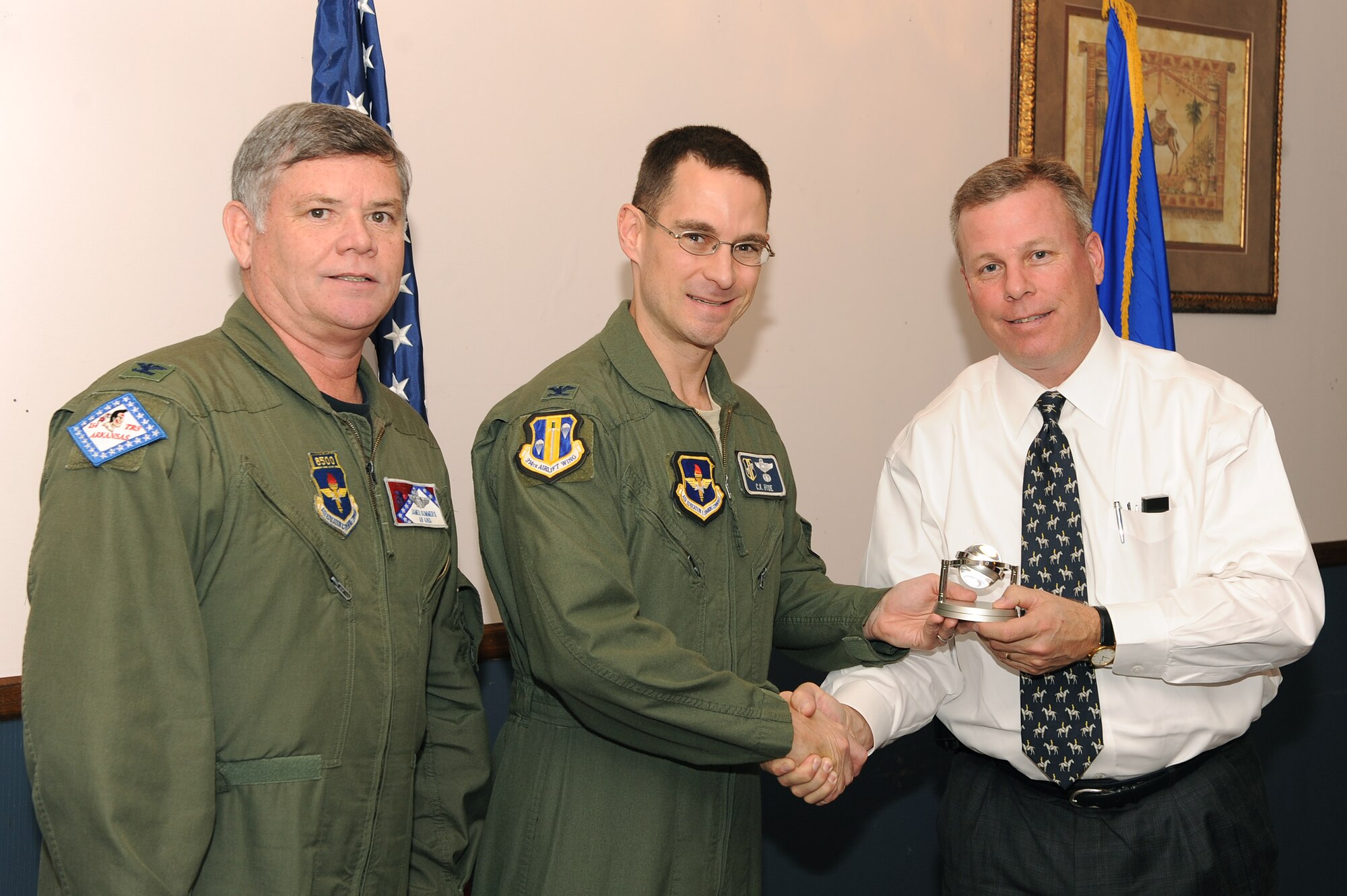 (From left) Col. Jim Summers, 189th Airlift Wing commander, and Col. C.K. Hyde, 314th Airlift Wing commander, present Jay Chessir, the Little Rock Regional Chamber of Commerce chief executive officer, with a memento from the Air Education Training Command Commander's Group Dec. 1 for his support during his two-year tenure with the civic group. The AETC Commander’s Group was created in 2003 to create an open dialogue between influential opinion leaders from the local community. (U.S. Air Force photo by Staff Sgt. Chad Chisholm)