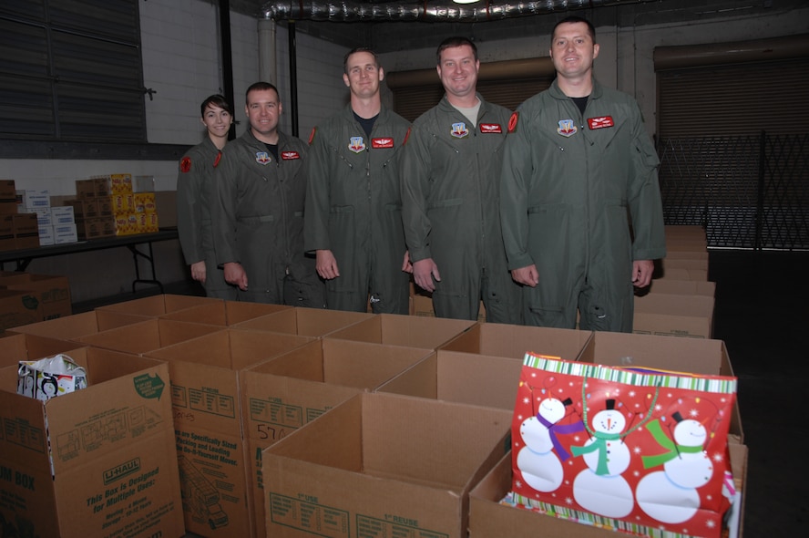 From left, SSgt Jenna Highfill, TSgt Ron Barthelt, TSgt Joe Westlake, 1st LT Quinton Langham and Capt Richard Reyna, all of the 16 ACCS pause for a group shot while helping with the 116th Air Control Wing Family to Family program Tuesday Dec. 1 at Robins AFB, GA. The program gives unit members a chance to help the community and other military families by donating gifts and time to those needing a help during the holiday season. (GA ANG Photo by SMSgt Tom McKenzie)