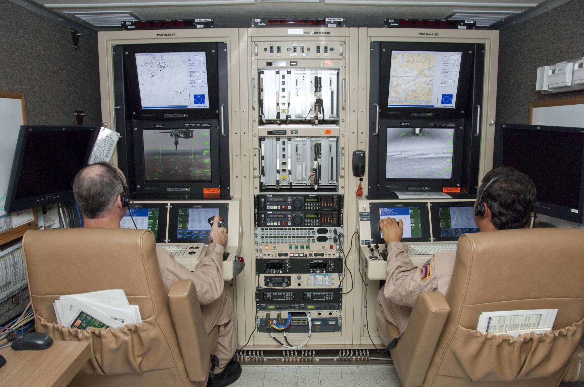 NASA pilots Troy Asher and Hernan Posada fly the agency's Predator B Ikhana from its ground control station at NASA's Dryden Flight Research Center on Edwards Air Force Base, Calif. The remotely piloted aircraft is used for a variety of environmental science and aeronautical research roles. (NASA Photo / Tony Landis)
