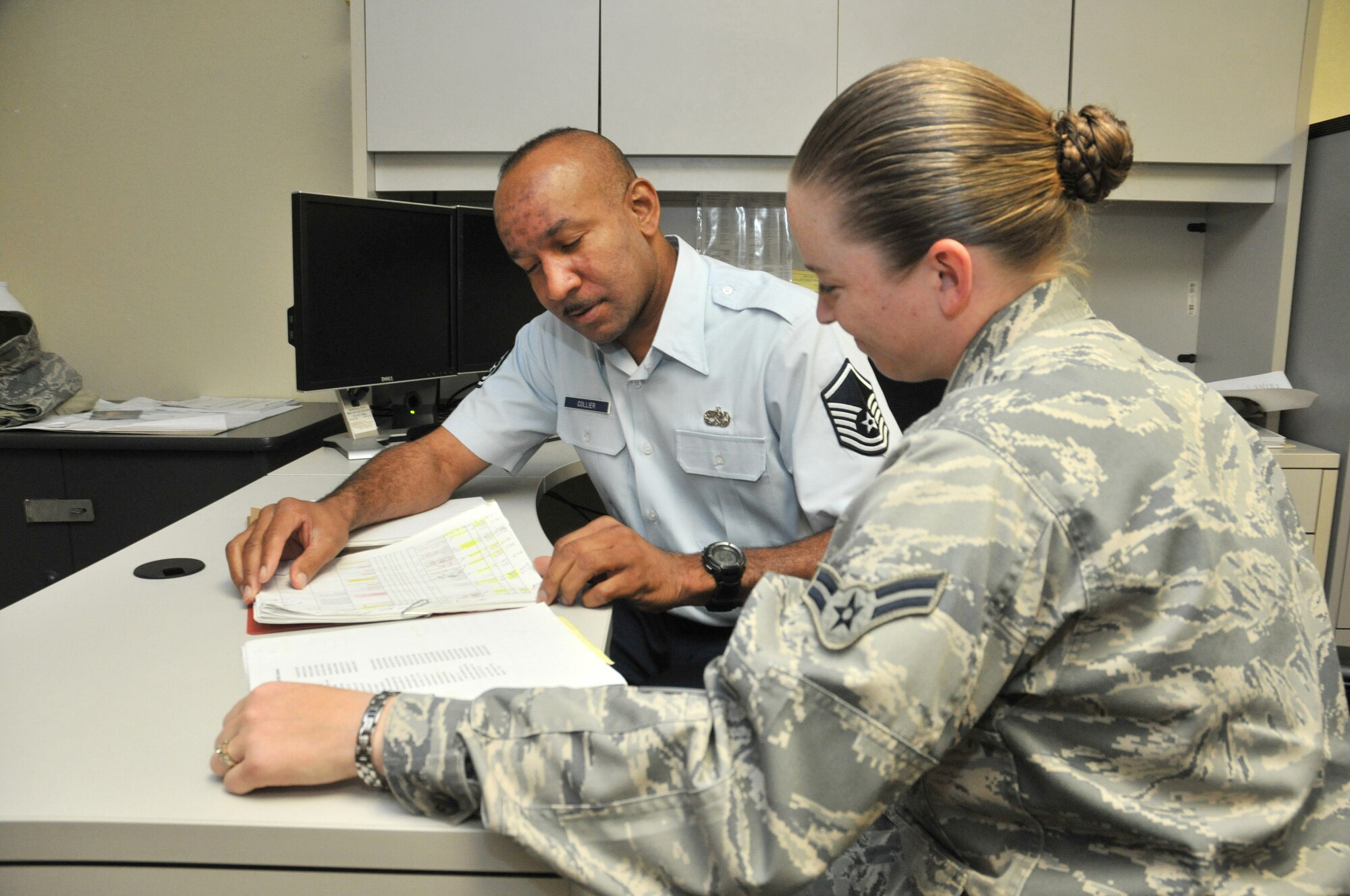 Sergeant Collier reviews the records of Airman  Kelly Metcalf, 81st LRS, in advance of her upcoming deployment.  (U.S. Air Force photo by Adam Bond)
