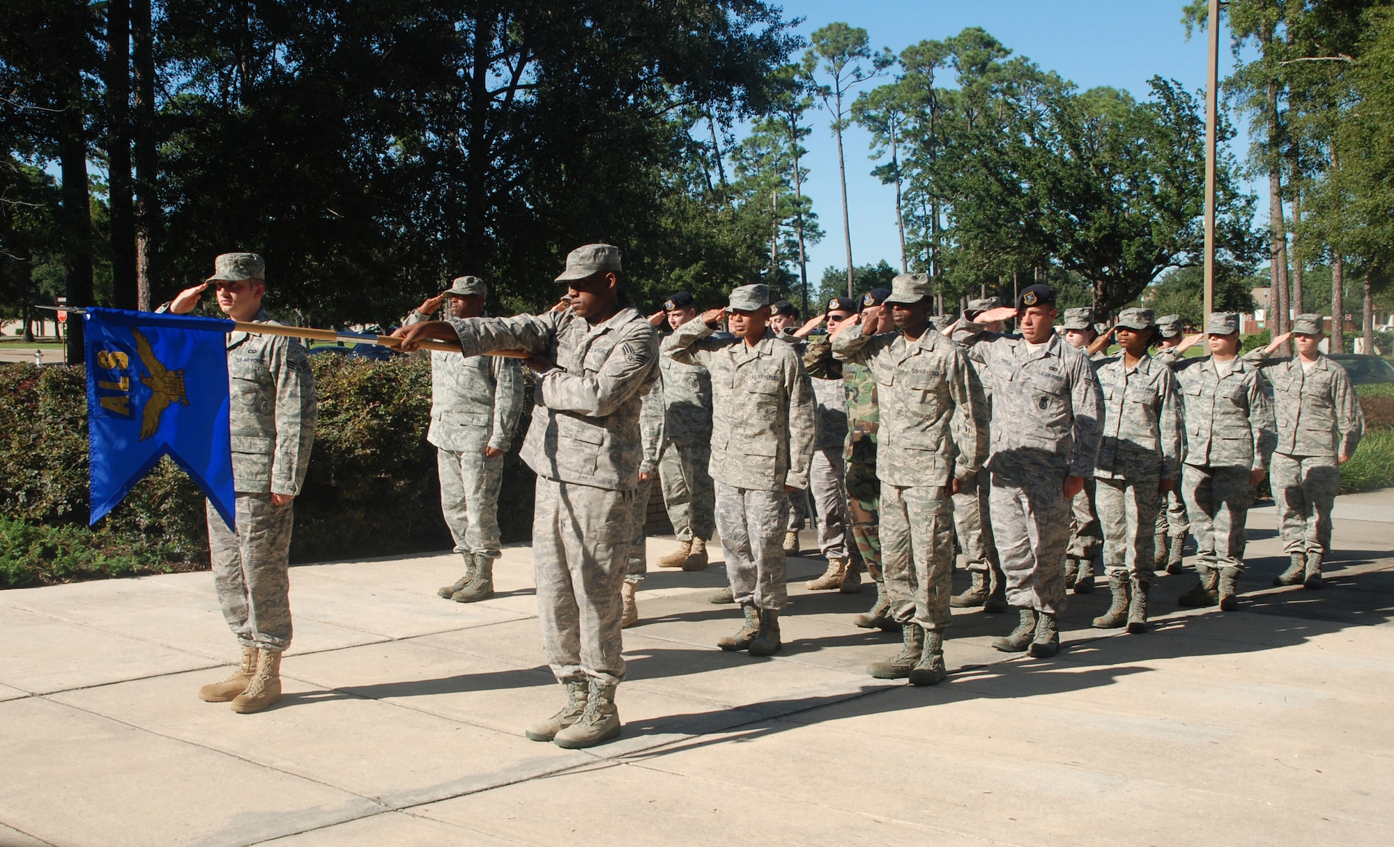 ALS Class 09-7 presents arms during retreat outside the ALS building.  In addition to classroom activities, students also participate in reveille and open ranks inspections.   (U.S. Air Force photo by Senior Airman Kimberly Moore)