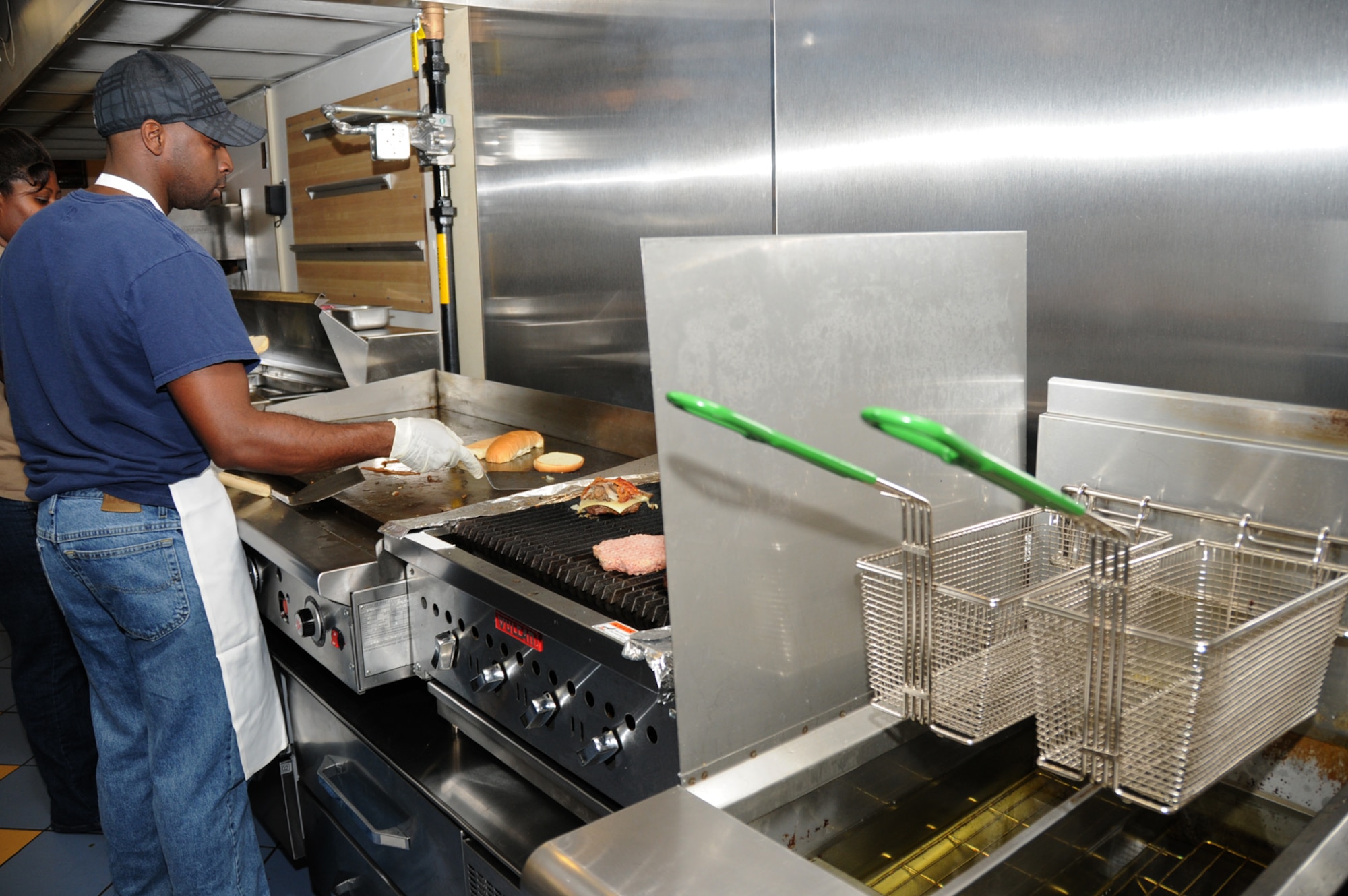 Tarvin Atkins cooks on the new equipment in the newly-renovated snack bar at Gaude Lanes. (U.S. Air Force photo by Kemberly Groue)