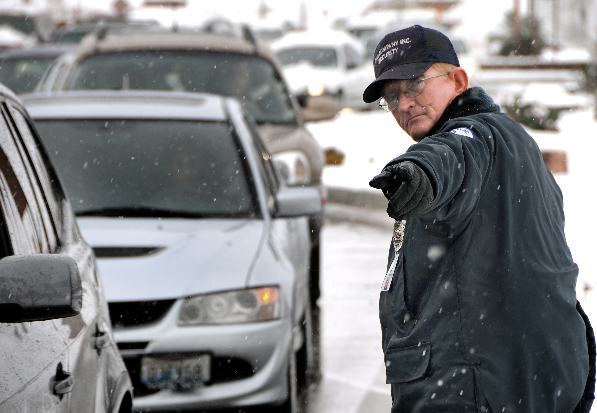 HOLLOMAN AIR FORCE BASE, N.M. -- Officer Rick Callahan, from TW and Associates Security Company, helps direct traffic here after a small snowstorm Dec. 1. The National Weather Service in El Paso, Texas, issued a winter storm warning from noon Nov. 30 to 5 a.m. Dec. 1. Between three and eight inches of snow was expected, according to NWS.(U.S.Air Force photo by Tech. Sgt. Chris Flahive)