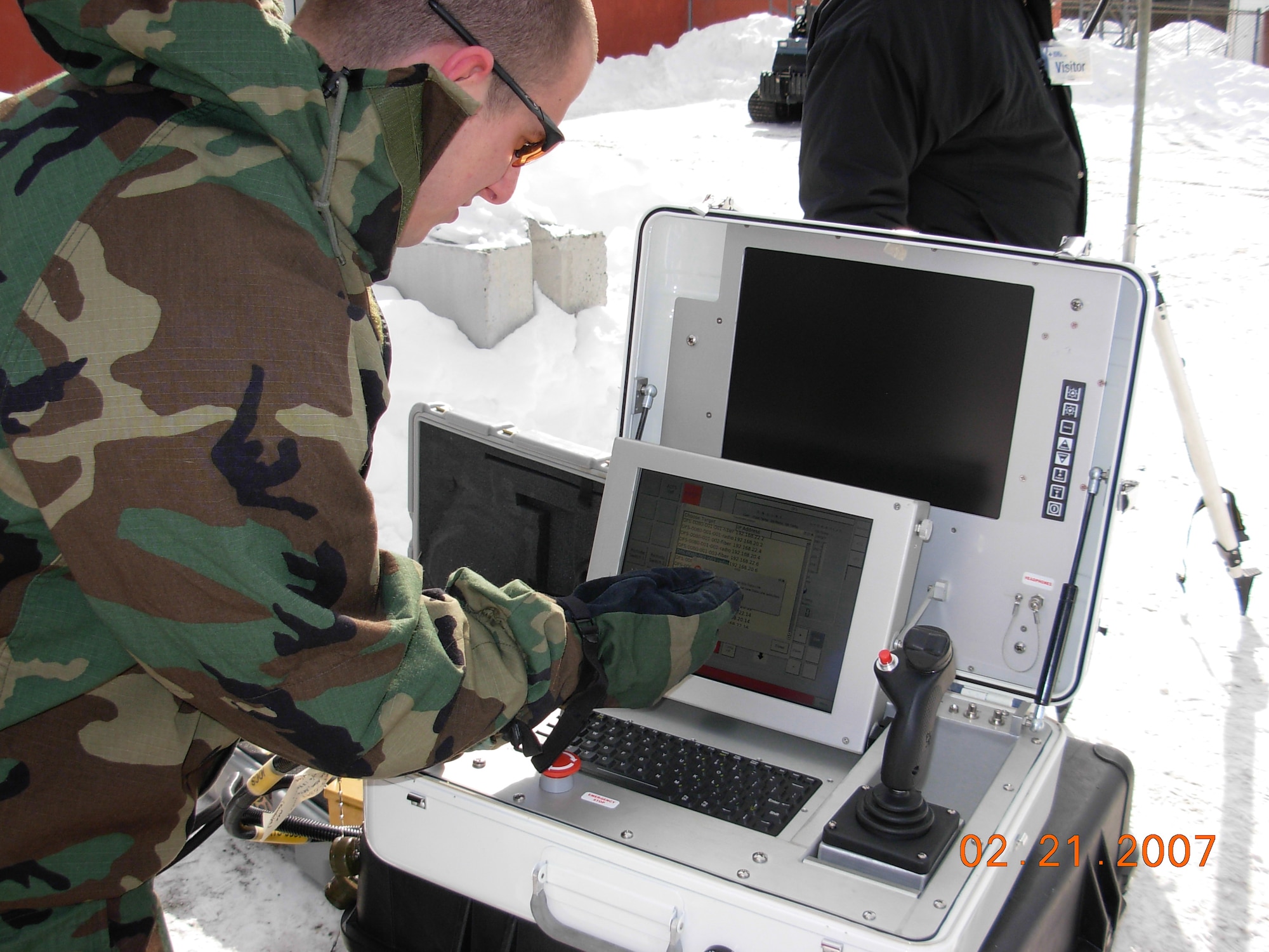 An Airman wearing arctic gloves operates an All-purpose Remote Transport System touchscreen menu.  This type of testing showed someone wearing heavy gloves needed to touch the screen with a pencil or a stylus like what is used to sign the checkout screen. This is one of the many ongoing projects in the 53rd Wing's Agile Combat Support Division. The division tests new techonogies to save time, money and lives for the joint services. (U.S. Air Force photo).
