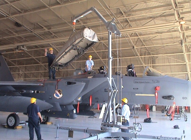 Maintainers at Nellis AFB, Nev., use the test crane to remove the canopy from an F-15E.  Testing showed by using this crane, it was easier to remove the canopy from some aircraft than others. (U.S. Air Force photo)

