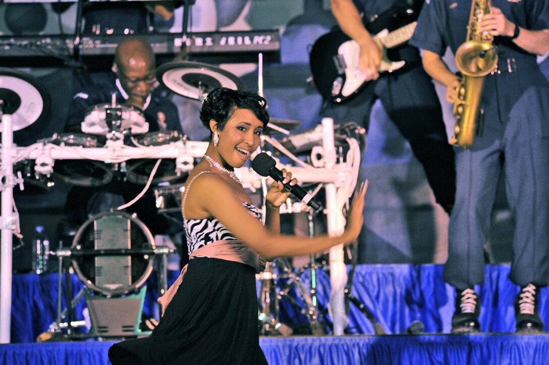 Staff Sgt. Aisha Smith performs for an audience of deployed U.S. and coalition forces July 14, 2009, in Southwest Asia. Tops In Blue officials are currently seeking new performers for the 2010 world tour. Sergeant Smith, a native of Richmond, Va., was a Tops In Blue vocalist for the 2009 tour. She is a public health craftsman with the 6th Aerospace Medicine Squadron at MacDill AFB, Fla. (U.S. Air Force photo/Staff Sgt. Robert Barney) 