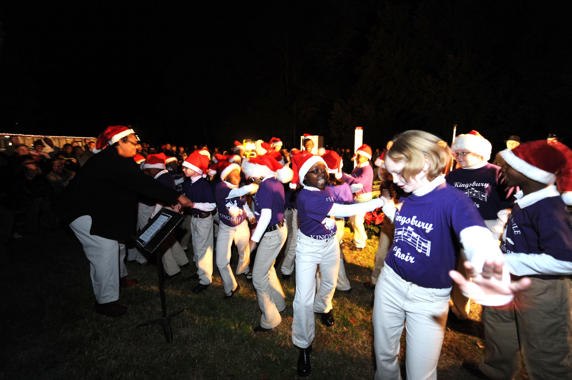 SUMTER, S.C. -- Children from the Kingsbury Elementary School Choir sing and dance to the delight of the crowd during the annual Fantasy of Lights Dec. 1, at Swan Lake Iris Gardens. The Sumter community makes many donations to keep this a holiday tradition. (U.S. Air Force photo/Tech. Sgt. Louis Rivers)