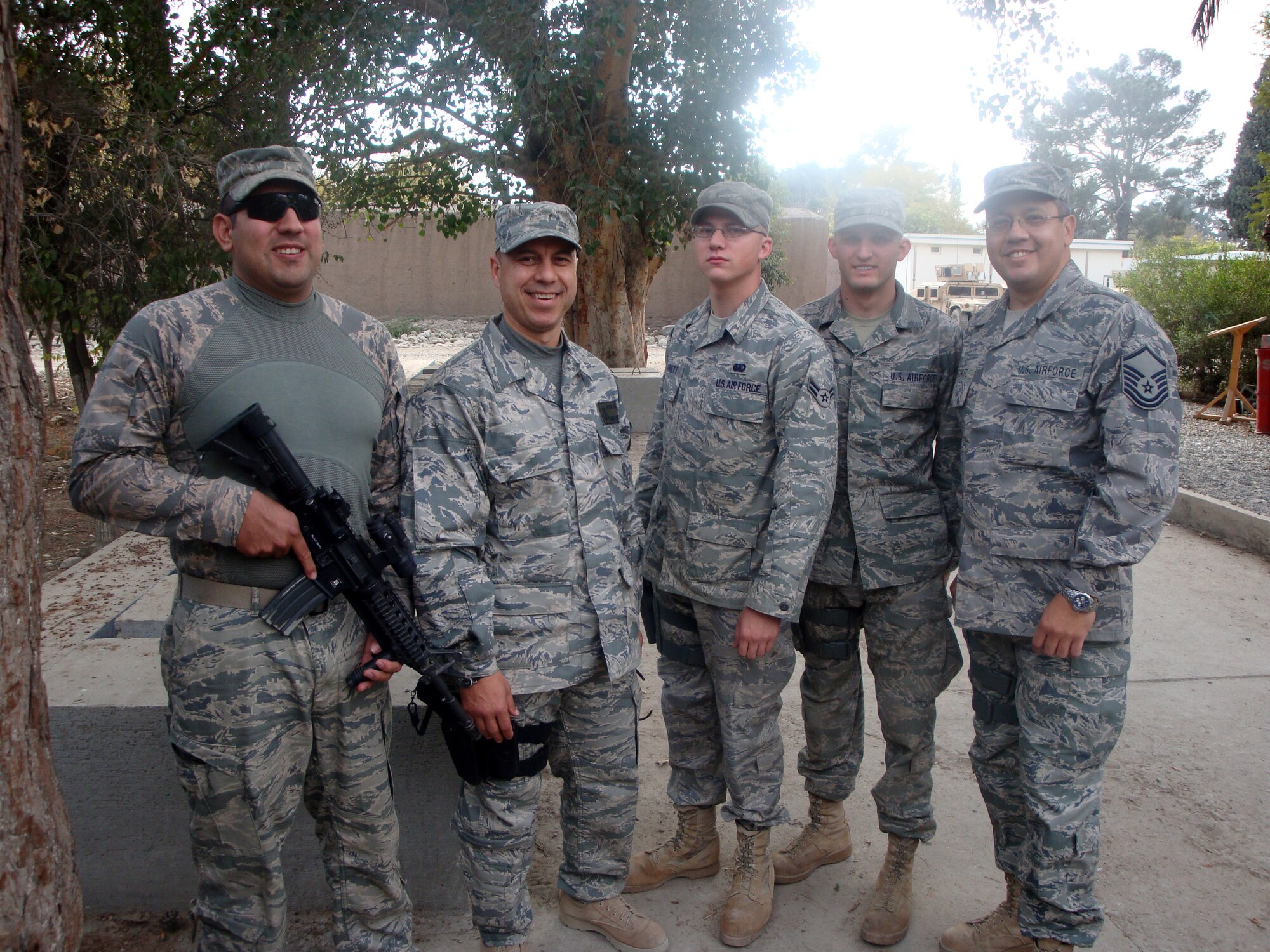 BAGRAM AIR FIELD, Afghanistan -- Four deployed Holloman Airmen run into their former Holloman command chief recently, Chief Master Sgt. Jeffrey Cui, who is their new command chief here. The Airmen are part of a provincial reconstruction team in Afghanistan. The former 49er chief ran into Staff Sgt. Noe Gutierrez, 49th Logistics Readiness Squadron, Airman 1st Class Max Barrett, Senior Airman Thomas Beil and Master Sgt. Robert Ituarte, all from the 49th Force Support Squadron. (Photo provided)        