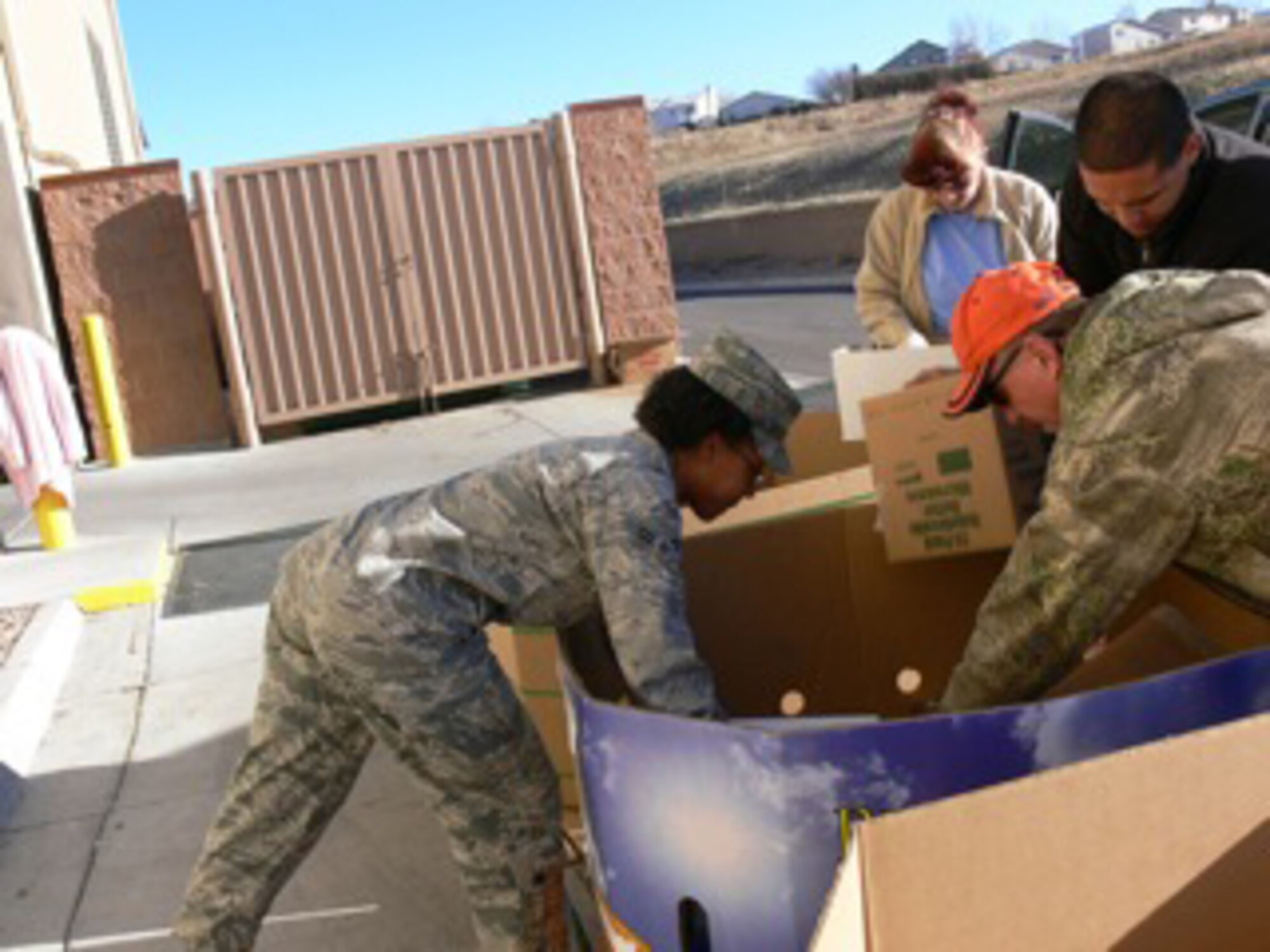 Airman Jessica Fryer, 21st Space Wing communications squadron, helps sort food into large bins Nov. 20 at the Care and Share Food Bank in Colorado Springs. Airman Fryer was among 40 Airmen and civilians from Peterson Air Force Base who volunteered at the regional food bank for the Harvest of Love food drive, a city-wide food drive that had tons of food coming into the warehouse. Care and Share serves as a regional bulk food distribution hub for more than 400 food pantries and soup kitchens in 31 counties. (Air Force photo by Monica Mendoza)

