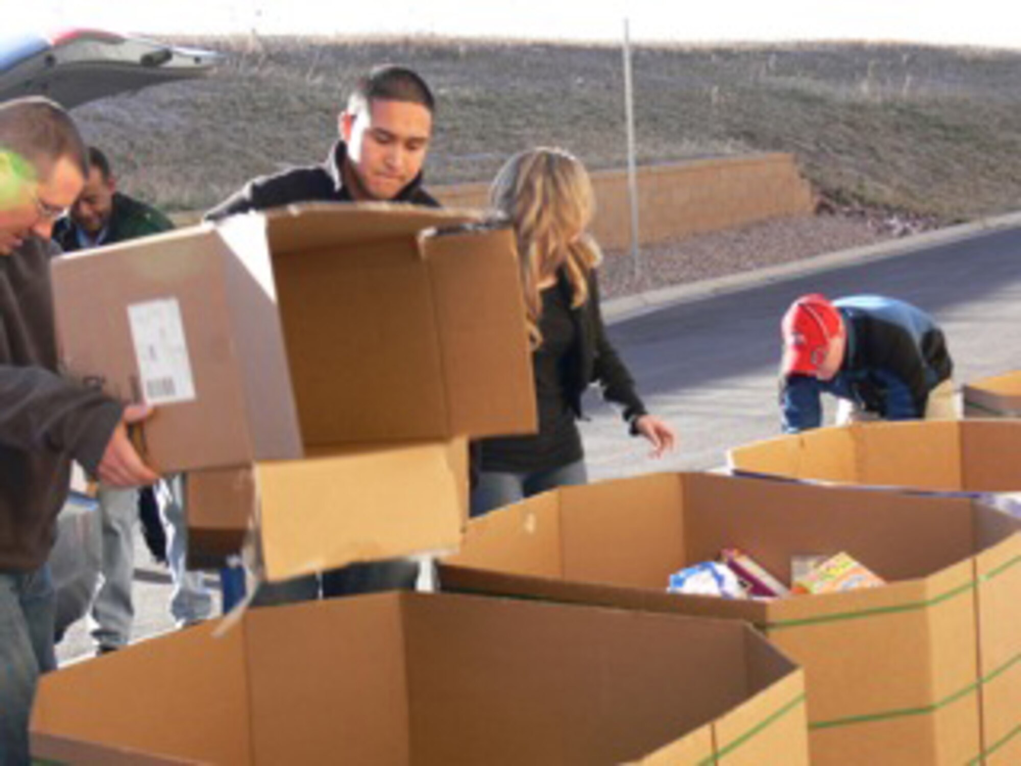 Airman Jon Rivera, 21st Space Wing Medical Group, sorts boxes of food into large bins Nov. 20 at the Care and Share Food Bank in Colorado Springs. Airman Rivera was among 40 Airmen and civilians from Peterson Air Force Base who volunteered at the regional food bank for the Harvest of Love food drive, a city-wide holiday food drive that had tons of food coming into the warehouse. Last year, Care and Share delivered more than 14.6 million pounds of food. (Air Force photo by Monica Mendoza)