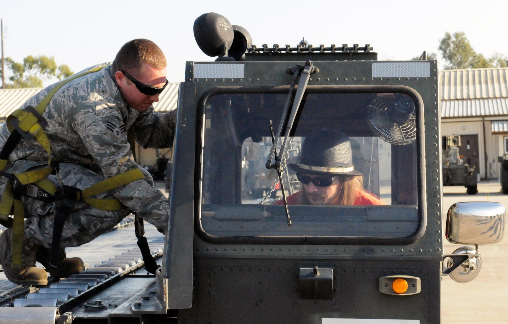 Senior Airman Brent Farris, 728th Air Mobility Squadron, directs Kid Rock on the operations of a K-loader during Rocks visit for Tour for the Troops Tuesday Dec. 1, 2009, at Incirlik Air Base, Turkey. Kid Rock and the Twisted Brown Truck Band, singer/songwriter Jessie James and comedian Carlos Mencia kicked off the tour making Incirlik their first stop to thank the troops. The three entertainers also visited various places around the base including the 39th Security Forces Squadron, Incirlik’s American Forces Network studio and the 39th Force Support Squadron. (U.S. Air Force photo/Staff Sgt. Raymond Hoy)