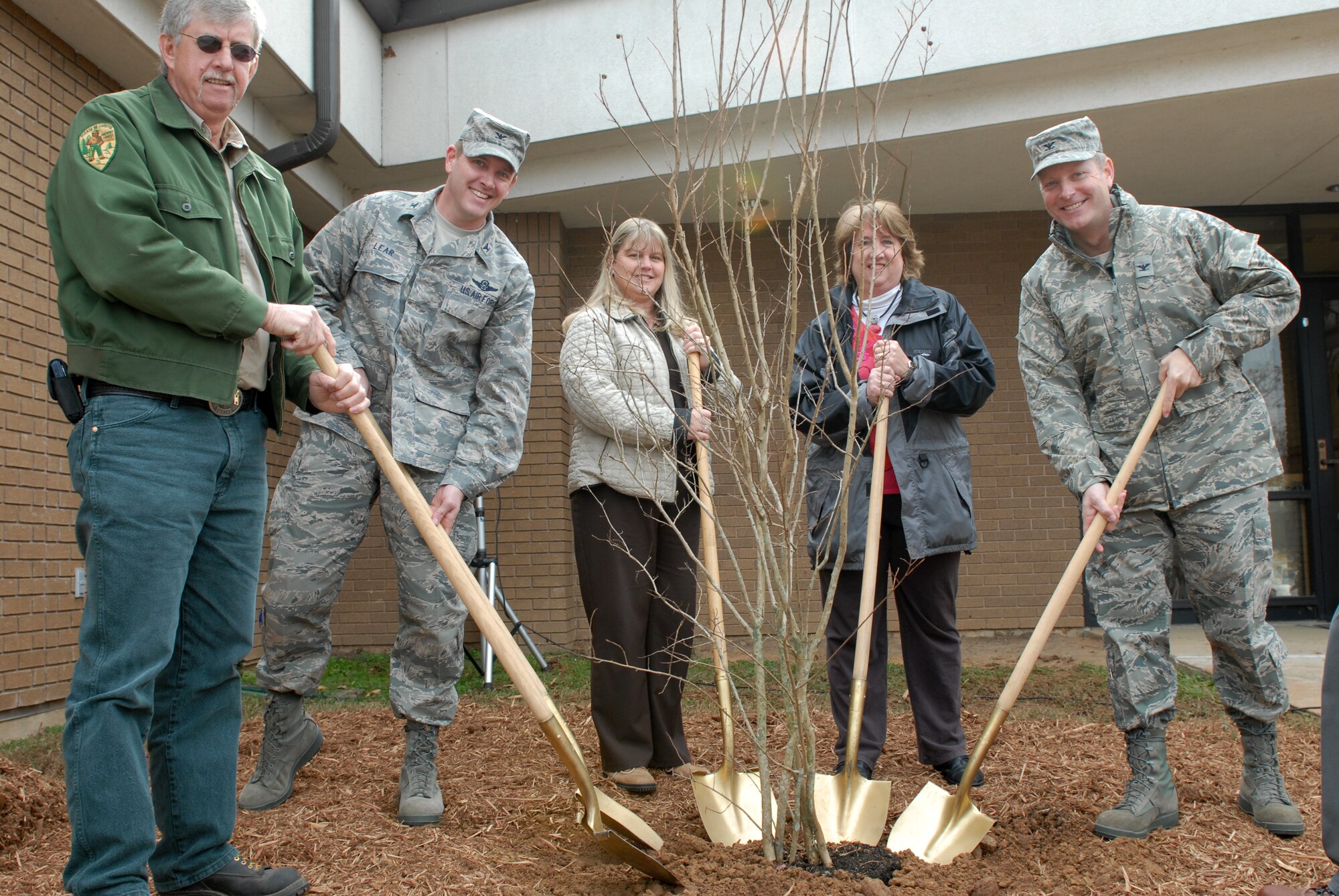 (From left to right) Ken Coley, Arkansas Forestry Commission assistant director; Col. Kirk Lear, 314th Airlift Wing vice commander; Alana Myers, Child Development Center director; Janet Carson, University of Arkansas Cooperative Extension Service statewide master gardener coordinator; and Col. Michael Zick, 19th Airlift Wing vice commander; plant a tree Dec. 1 during the base’s Arbor Day ceremony. Arbor Day originally began in 1885 and was created by a Nebraska pioneer Sterling Morton. (U.S. Air Force photo by Senior Airman Christine Clark)