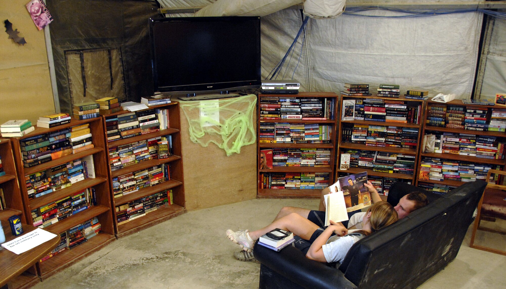 The son of Lt. Col. Bill Otter, who recently redeployed from Kandahar Airfield as the 772nd Expeditionary Airlift Squadron commander, put together an Eagle Scout project in which more than 400 DVDs and more than 300 books were donated to the 451st Air Expeditionary Wing. Will Otter, a boy scout from Troop 23 in Cabot, Ark., sent 50 boxes filled with items donated from members within his community and Little Rock Air Force Base, Ark. In a letter he wrote to the wing he said collecting the donations was a challenging, but rewarding process and hopes all will be excited to read and watch them just as much as he was to send them. (U.S. Air Force photo/Senior Airman Timothy Taylor)
