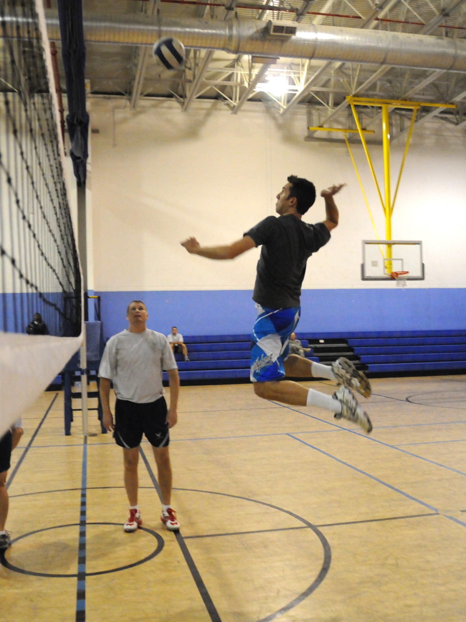 Jason McDonald, Argon ST/TTC Team network engineer, leaps into action with the Combined Air and Space Operations Center volleyball team against the 379th Expeditionary Operations Group team Nov. 28, 2009. The CAOC team emerged as the base champion in the Intramural Volleyball League for the third consecutive year. (U.S. Air Force Photo/Tech. Sgt. Jason W. Edwards)