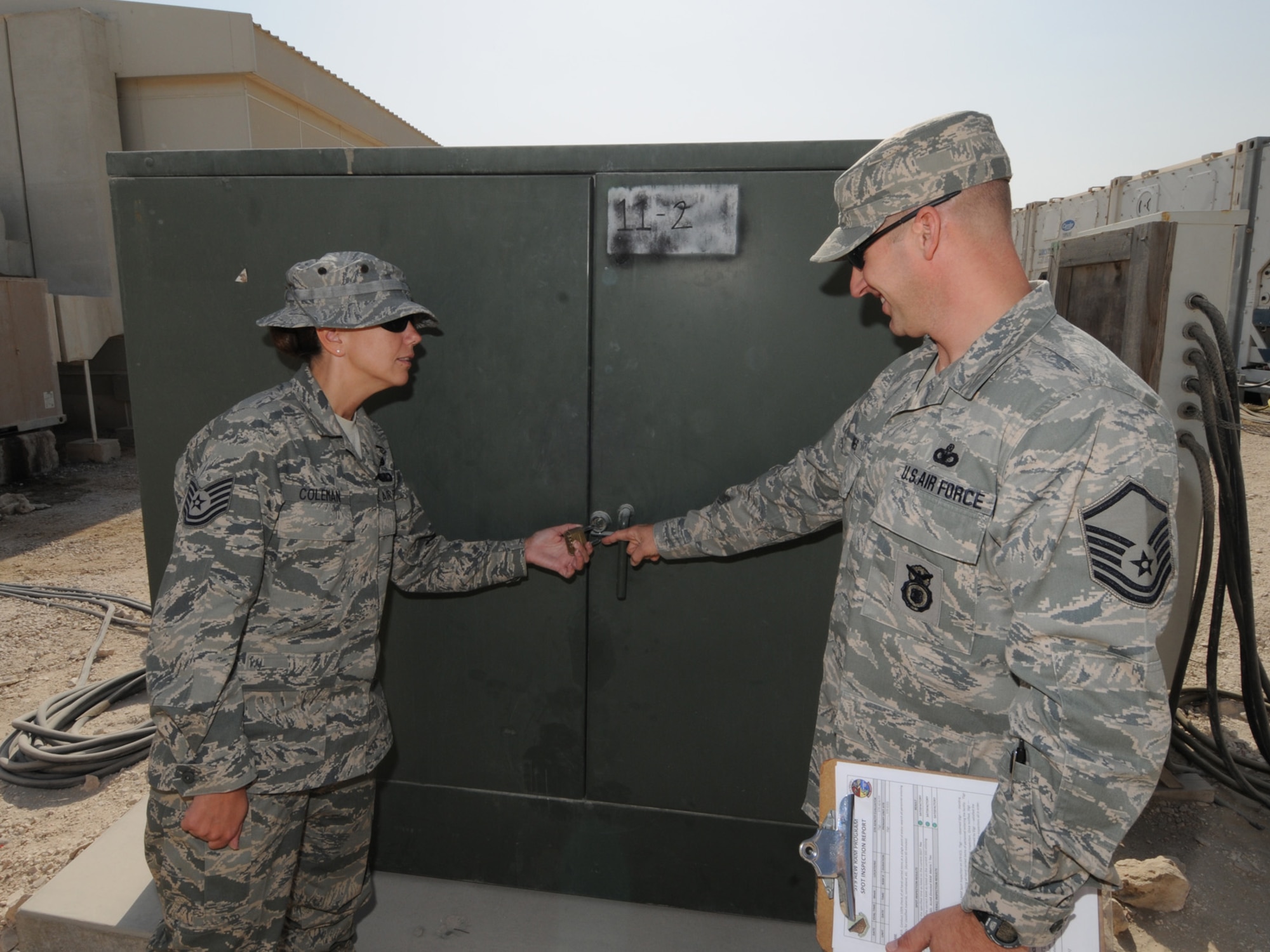 Right, Master Sgt. Kevin Jones, 379th Air Expeditionary Wing Force Protection NCOIC, conducts a random anti-terrorism measure spot inspection with Tech. Sgt. April Coleman, 379 AEW Area Defense Counsil defense paralegal, Dec. 2, 2009. The 379 AEW Force Protection office coordinates installation-wide efforts to reduce the vulnerability of deployed personnel and resources throughout the base. (U.S. Air Force Photo/Tech. Sgt. Jason W. Edwards)