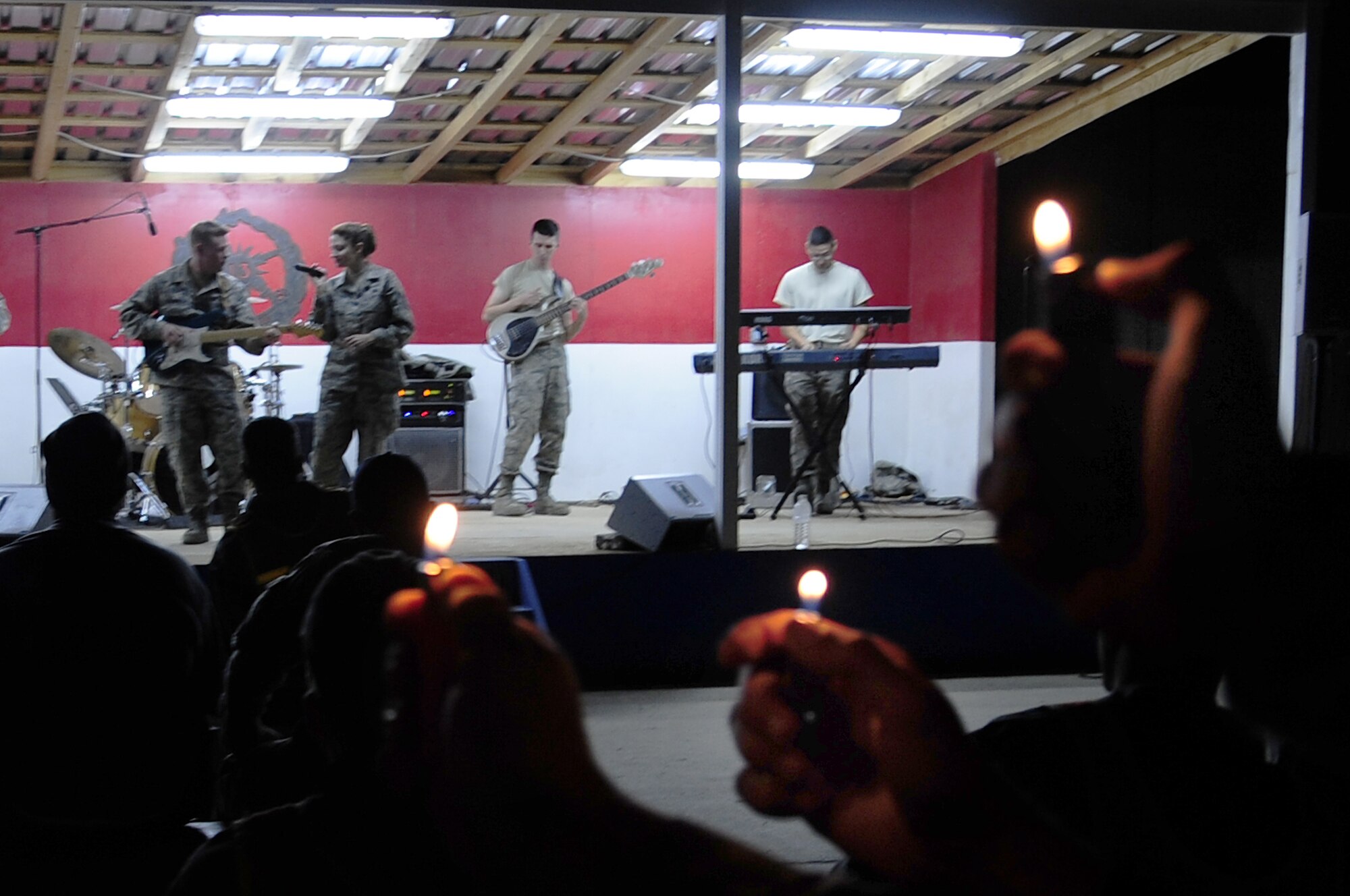 FORWARD OPERATING BASE HUNTER, Iraq -- United States Air Force members, Air Force Central Command rock band ‘Sirocco’, perform into the evening as U.S. Army Soldiers wave their lighters in the audience here, Nov. 29, 2009. Sirocco entertained servicemembers and civilians at Ali Base, Contingency Operating Base Adder and Forward Operating Base Hunter, Iraq, over the Thanksgiving Day weekend. (U.S. Air Force photo/Senior Airman Tony R. Ritter) 
