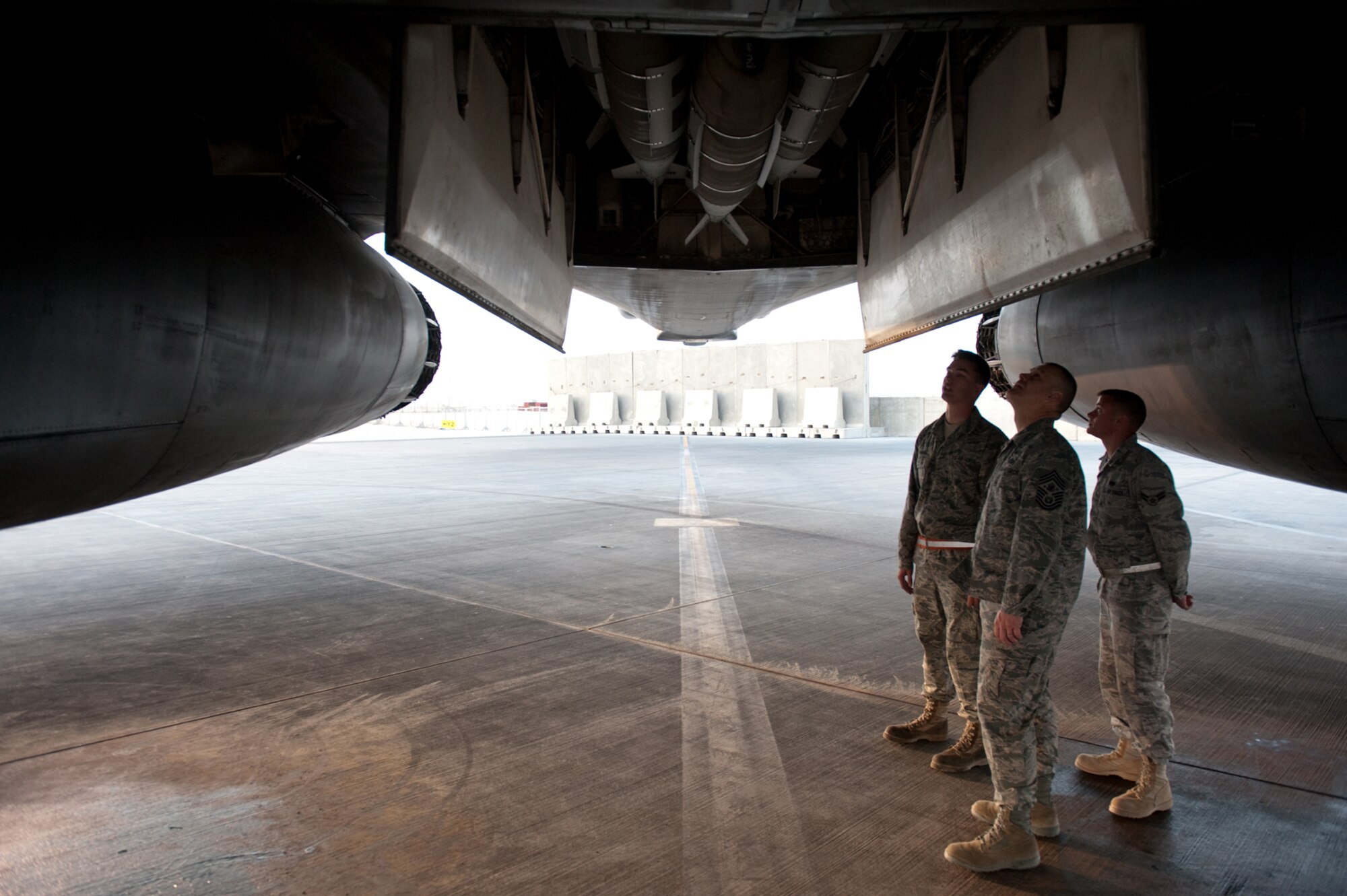 Chief Master Sgt. of the Air Force James A. Roy, center, gets a B-1B Lancer tour from Airman 1st Class Brian Arbogast and Senior Airman Chris Sansing, Nov. 30, 2009. Chief Roy is touring the U.S. Air Forces Central Command area of responsibility, visiting with Airmen and addressing numerous issues affecting service members who are deployed in support of operations Iraqi Freedom and Enduring Freedom. (U.S. Air Force photo/Staff Sgt. Robert Barney/Released)