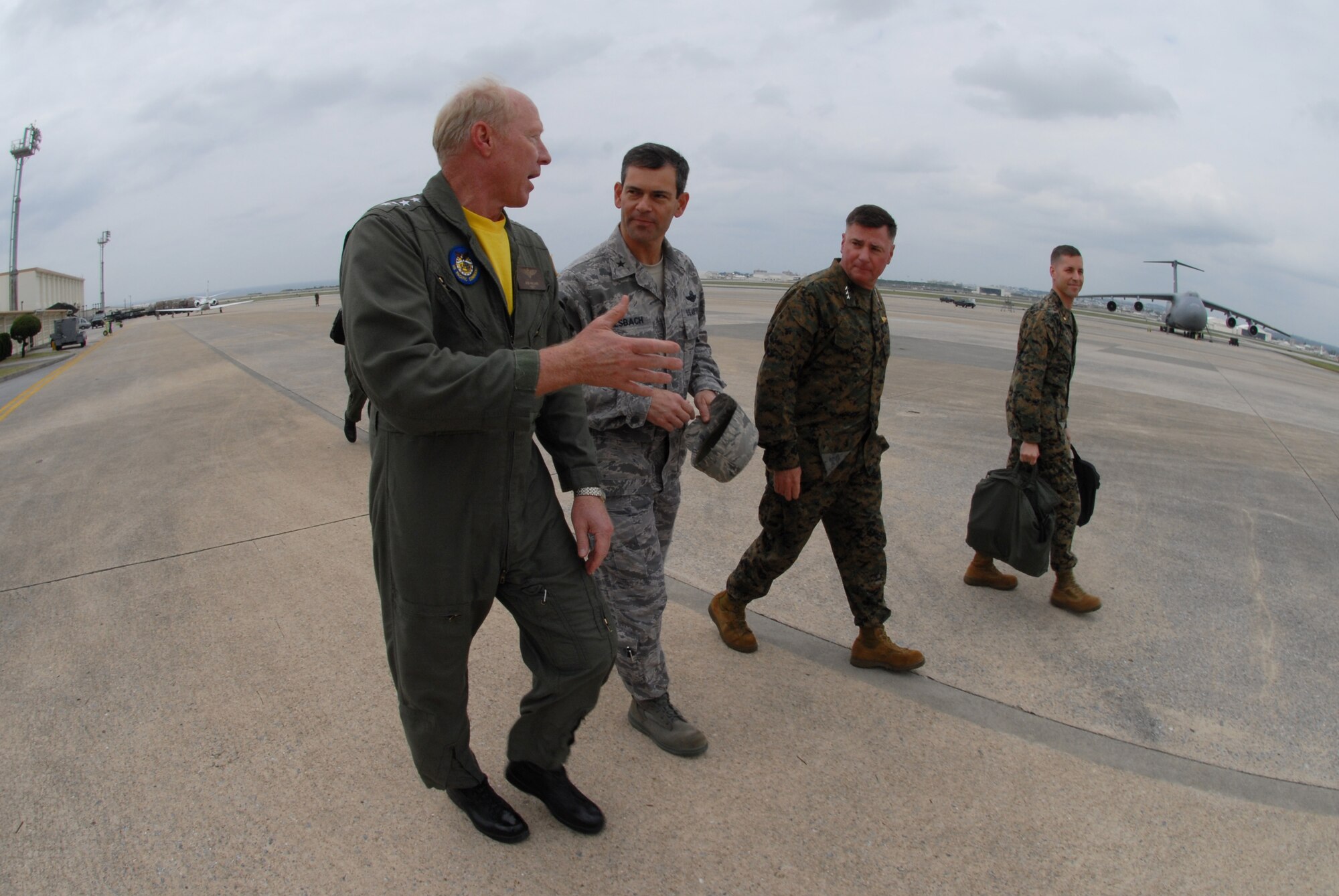 Admiral Robert F. Willard, U.S. Pacific Command commander (left), speaks with Brig. Gen. Ken Wilsbach (center), 18th Wing commander, and Marine Lt. Gen. Terry G. Robling, III Marine Expeditionary Force and Marine Corps Bases Japan commander, during the admiral's trip to Okinawa Dec. 1-2. Admiral Willard took command of USPACOM in October. (U.S. Air Force photo / Airman 1st Class Amanda Grabiec)