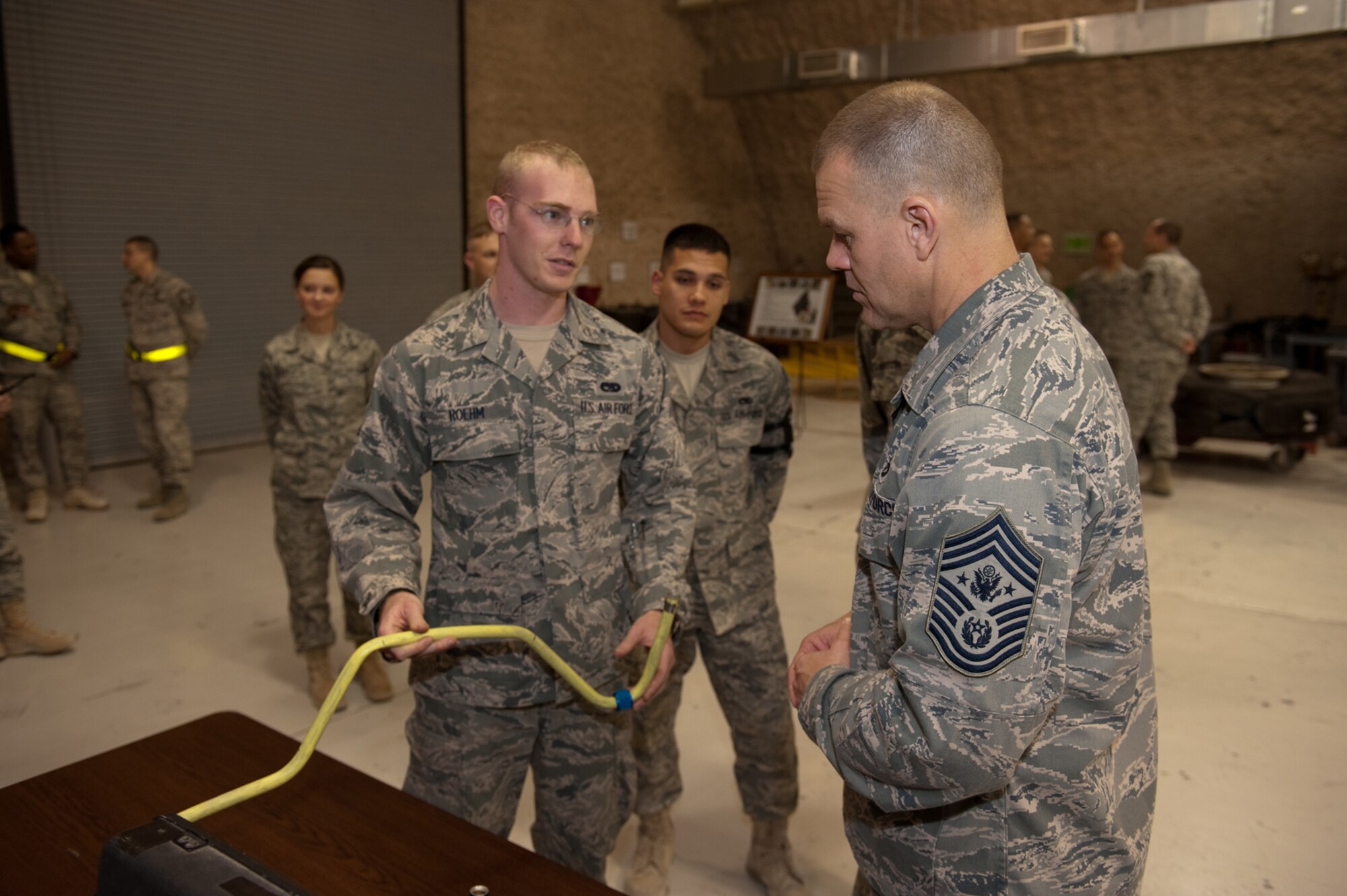 Chief Master Sgt. of the Air Force James A. Roy receives a briefing from Senior Airman Brock Roehm on his role in fabricating tubing and other parts in the 397th Expeditionary Maintenance Squadron fabrication flight, Nov. 30, 2009. Chief Roy is touring the U.S. Air Forces Central Command area of responsibility, visiting with Airmen and addressing numerous issues affecting service members who are deployed in support of operations Iraqi Freedom and Enduring Freedom. (U.S. Air Force photo/Staff Sgt. Robert Barney)