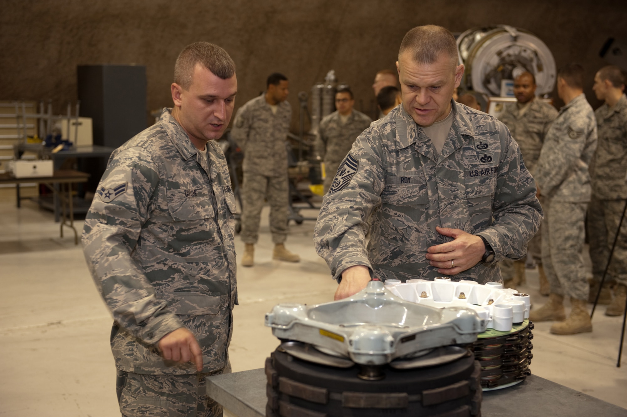 Chief Master Sgt. of the Air Force James A. Roy receives a briefing from Airman 1st Class Marcus Taylor on his role in maintaining aircraft brakes, Nov. 30, 2009. Chief Roy is touring the U.S. Air Forces Central Command area of responsibility, visiting with Airmen and addressing numerous issues affecting service members who are deployed in support of operations Iraqi Freedom and Enduring Freedom. (U.S. Air Force photo/Staff Sgt. Robert Barney)