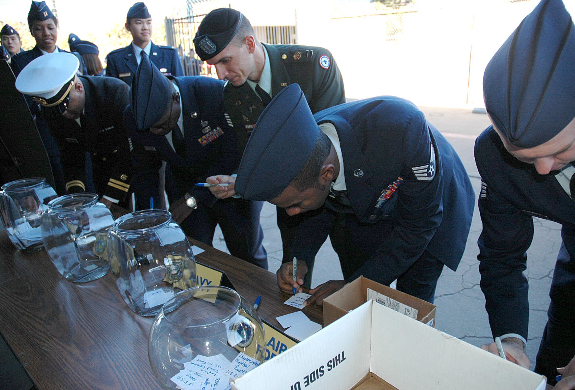 Members of the Armed Services sign their names for the car giveaway at the Jay Leno Show’s military tribute on Thanksgiving Day at NBC Studios, Burbank, Calif., Nov. 26. Each branch was represented in the all-military audience, including Air Force members from Los Angeles Air Force Base, Vandenberg AFB and March Air Reserve Base. (Photo by 2nd Lt. Mara Title)