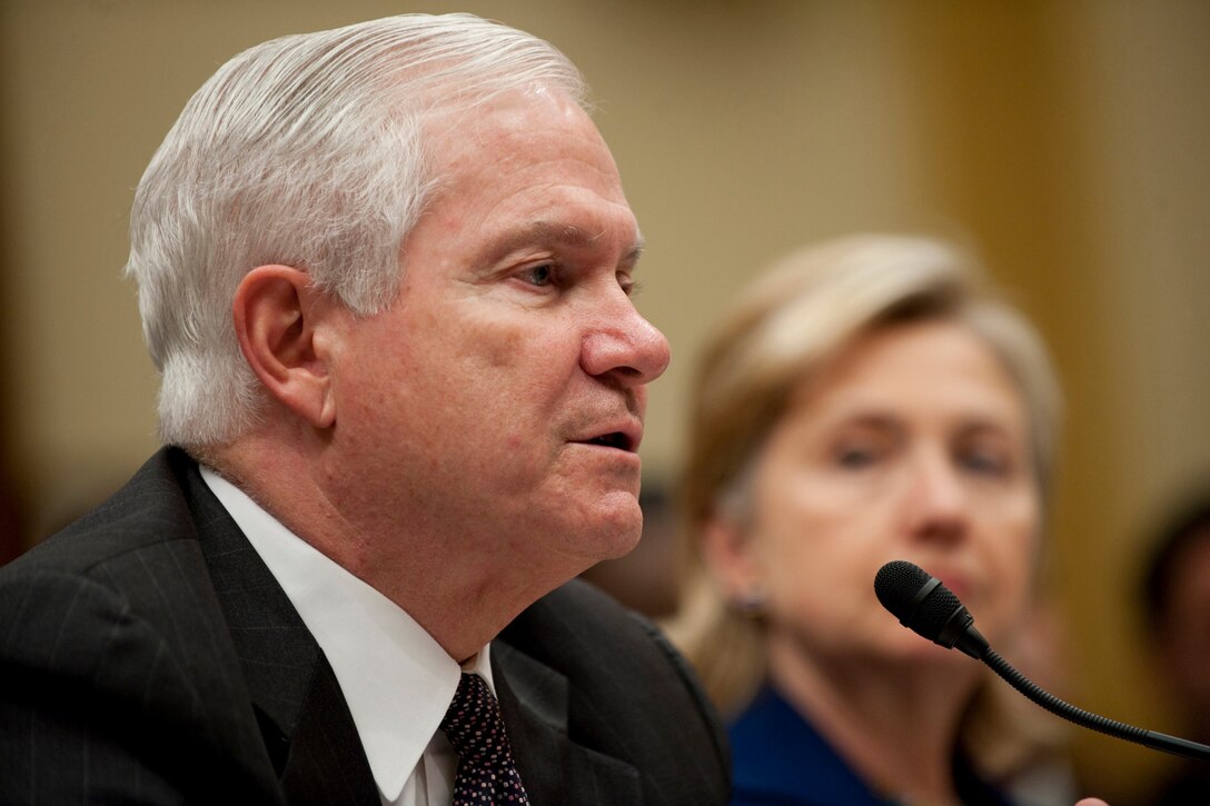 Defense Secretary Robert M. Gates, left, and Secretary of State Hillary Rodham Clinton, right, testify to the House Committee on Foreign Relations regarding President Barack Obama's announcement that he is sending an additional 30,000 troops to the war in Afghanistan, Rayburn House Office Building, Dec. 2, 2009.