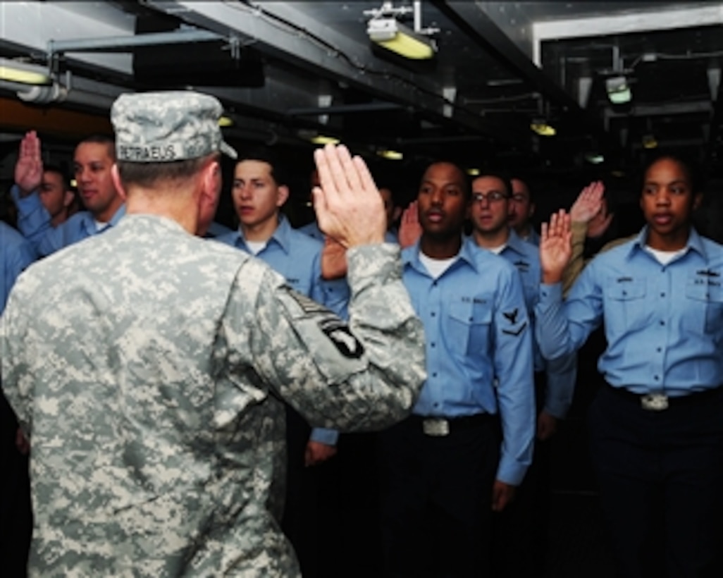 Commander of the U.S. Central Command Gen. David H. Petraeus, U.S. Army, reenlists sailors aboard the aircraft carrier USS Nimitz (CVN 68) while the ship is underway in the Gulf of Oman on Nov. 26, 2009.  The Nimitz and embarked Carrier Air Wing 11 are conducting operations in the Central Command area of responsibility.  