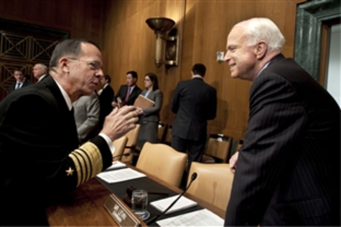 Navy Adm. Mike Mullen, chairman of the Joint Chiefs of Staff, speaks with Sen. John McCain, R-Ariz., before testifying to the Senate Armed Services Committee at the Dirksen Senate Office Building in Washington, D.C., Dec. 2, 2009. Mullen was scheduled to testify on President Barack Obama's decision to send an additional 30,000 troops to the war in Afghanistan.