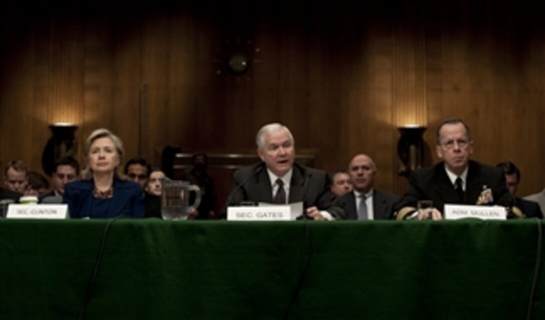 Secretary of State Hillary Rodham Clinton (left), Secretary of Defense Robert M. Gates and Chairman of the Joint Chiefs of Staff Adm. Mike Mullen (right), U.S. Navy, testify before the Senate Armed Services Committee regarding President Barack Obama's announcement that he is sending an additional 30,000 troops to Afghanistan in the Dirksen Senate Office Building in Washington, D.C., on Dec. 2, 2009.  