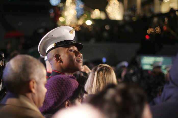 NEW YORK -- A Marine watches the stage during NBC's 77th Annual Live Holiday Celebration, Dec. 2. Marines from numerous local units attended the event as special guests in front of the stage for the evenings celebration, and Marines from 6th Communications Battalion, 4th Marine Logistics Group, who recently returned from an Iraq deployment joined New York City mayor Michael Bloomberg and musicians Michael Buble and Aretha Franklin in lighting the 76 ft. Christmas Tree. (Official Marine Corps photo by Sgt. Randall A. Clinton)