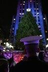 NEW YORK -- A Marine watches the stage during NBC's 77th Annual Live Holiday Celebration, Dec. 2. Marines from numerous local units attended the event as special guests in front of the stage for the evenings celebration, and Marines from 6th Communications Battalion, 4th Marine Logistics Group, who recently returned from an Iraq deployment joined New York City mayor Michael Bloomberg and musicians Michael Buble and Aretha Franklin in lighting the 76 ft. Christmas Tree. (Official Marine Corps photo by Sgt. Randall A. Clinton)