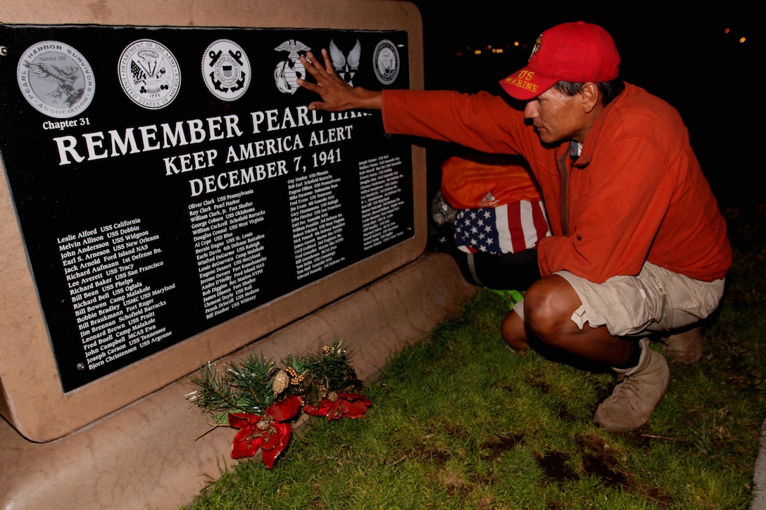 Eddie Gray, a former Marine rifleman with 1st Battalion, 6th Marines, 2nd Marine Division, makes a brief stop in Oceanside, Calif., Dec. 3, to read a Pearl Harbor memorial during a 12,000-mile walk around the U.S. perimeter. Gray began the walk to honor the sacrifices of all service members after losing more than 14 comrades in the Iraqi and Afghan conflicts. The journey began almost two years ago and he expects to finish in the next three years.