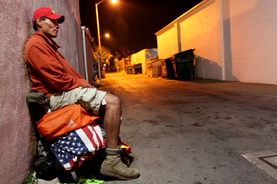 Eddie Gray, a former Marine rifleman with 1st Battalion, 6th Marines, 2nd Marine Division, sits on top of his pack for a brief rest in Oceanside, Calif., Dec. 3, before continuing a 12,000-mile walk around America’s perimeter. Gray began the walk to honor the sacrifices of all service members after losing more than 14 comrades in the Iraqi and Afghan conflicts. The journey began almost two years ago and he expects to finish in the next three years.