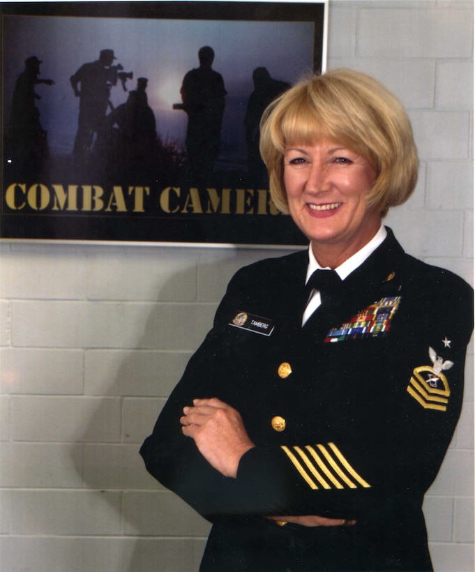 Navy Senior Chief Journalist Millie (Tamberg) Perera poses for a photo at the Combat Camera facility in Norfolk, Va., where she was assigned as operations chief. Now a Government Serice employee, she is the Managing Editor for Hawaii Marine, the base newspaper for Marine Corps Base Hawaii, Kaneohe Bay. The 26-year Navy veteran served during Vietnam and has since been deployed to most every war and conflict from the Gulf War to operations Enduring Freedom and Iraqi Freedom, as a journalist, photojournalist and public affairs officer for ship and shore-based commands.