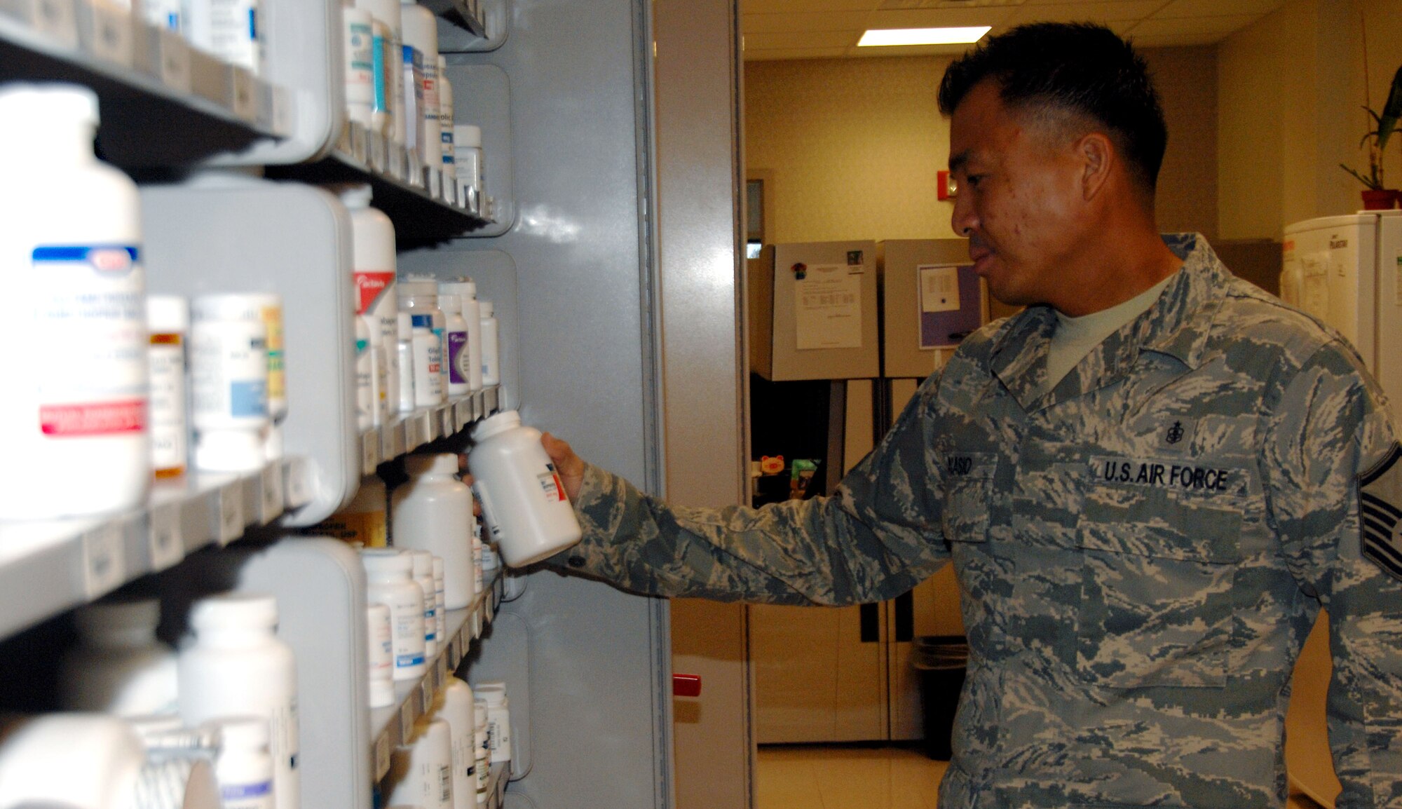 ANDERSEN AIR FORCE BASE, Guam - Master Sgt. Danny Acasio, 36th Medical Support Squadron NCO-in-charge of pharmacy services, places a bottle of medication on a shelf in the clinic pharmacy here Dec. 2. The pharmacy processes an average of 150 prescriptions per day. (U.S. Air Force photo by Senior Airman Shane Dunaway)