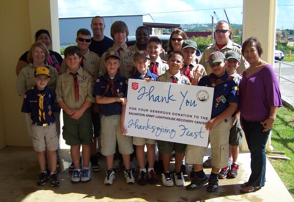 ANDERSEN AIR FORCE BASE, Guam - Members of Boy Scout Troop 20 and Cub Scout Pack 20 pose for a group photo after making a donation to the Guam Salvation Army here Nov. 21. The troop and pack donated more than 1,700 food items. (Courtesy photo)