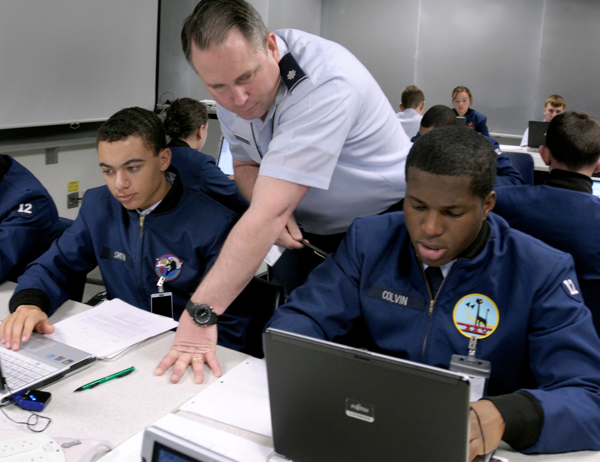 Lt. Col. Jeff Boleng looks over then-Cadets 3rd Class Bradford Smith and James Colvin III during a computer science course at the Air Force Academy in Colorado Springs, Colo., Feb. 2, 2009. The Academy officially received its 10-year accreditation from the Higher Learning Commission of the North Central Association of Colleges and Schools Oct. 27. Colonel Boleng is the deputy department head for the Department of Computer Science and an associate professor. (U.S. Air Force photo/David Armer)