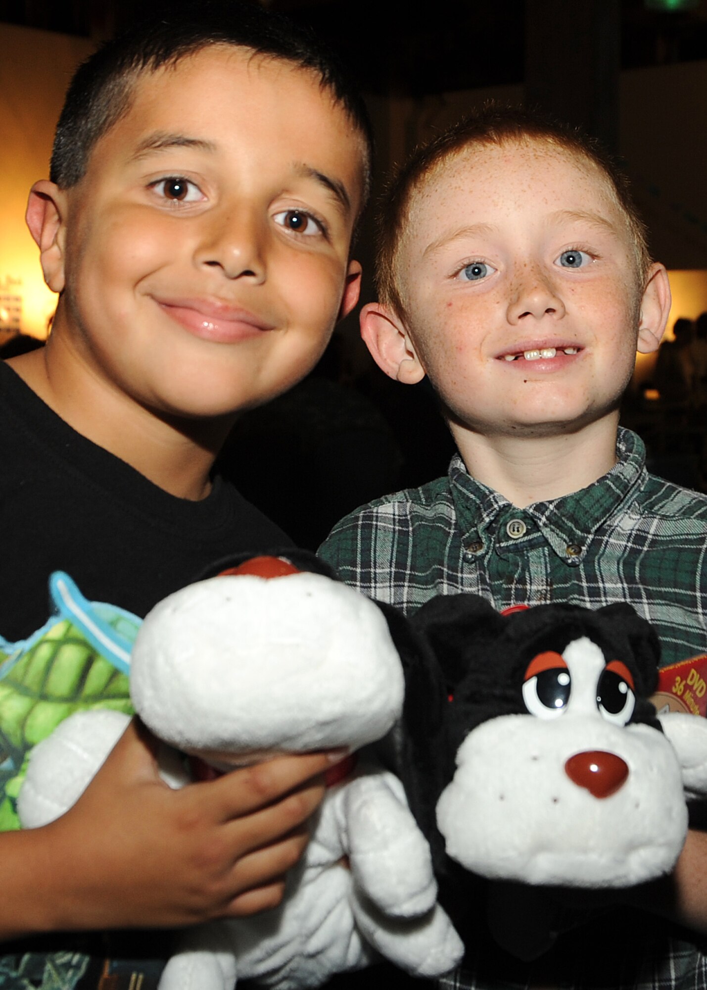 Ricardo Dias (left) and Samuel Beam make friends with their newly adopted Pound Puppies during the 8th annual Harvest Fest held at the Fort McArthur Youth Center, San Pedro, Calif., Nov. 19. Children and staff from the Youth Programs prepared food for the celebration and the children demonstrated what they’ve learned through the YP classes. Each military child received a new Pound Puppy, which was shared by the Los Angeles Air Force Base Child Development Center from a donation they received. (Photo by Joe Juarez)