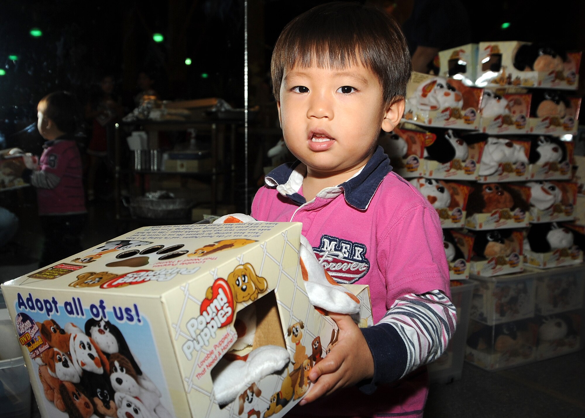 A boy “adopts” his Pound Puppy during the 8th annual Harvest Fest held at the Fort McArthur Youth Center, San Pedro, Calif., Nov. 19. Each military child received a new Pound Puppy, which was shared by the Los Angeles Air Force Base Child Development Center from a donation they received. Children and staff from the Youth Programs prepared food for the celebration and the children demonstrated what they’ve learned through the YP classes. (Photo by Joe Juarez)