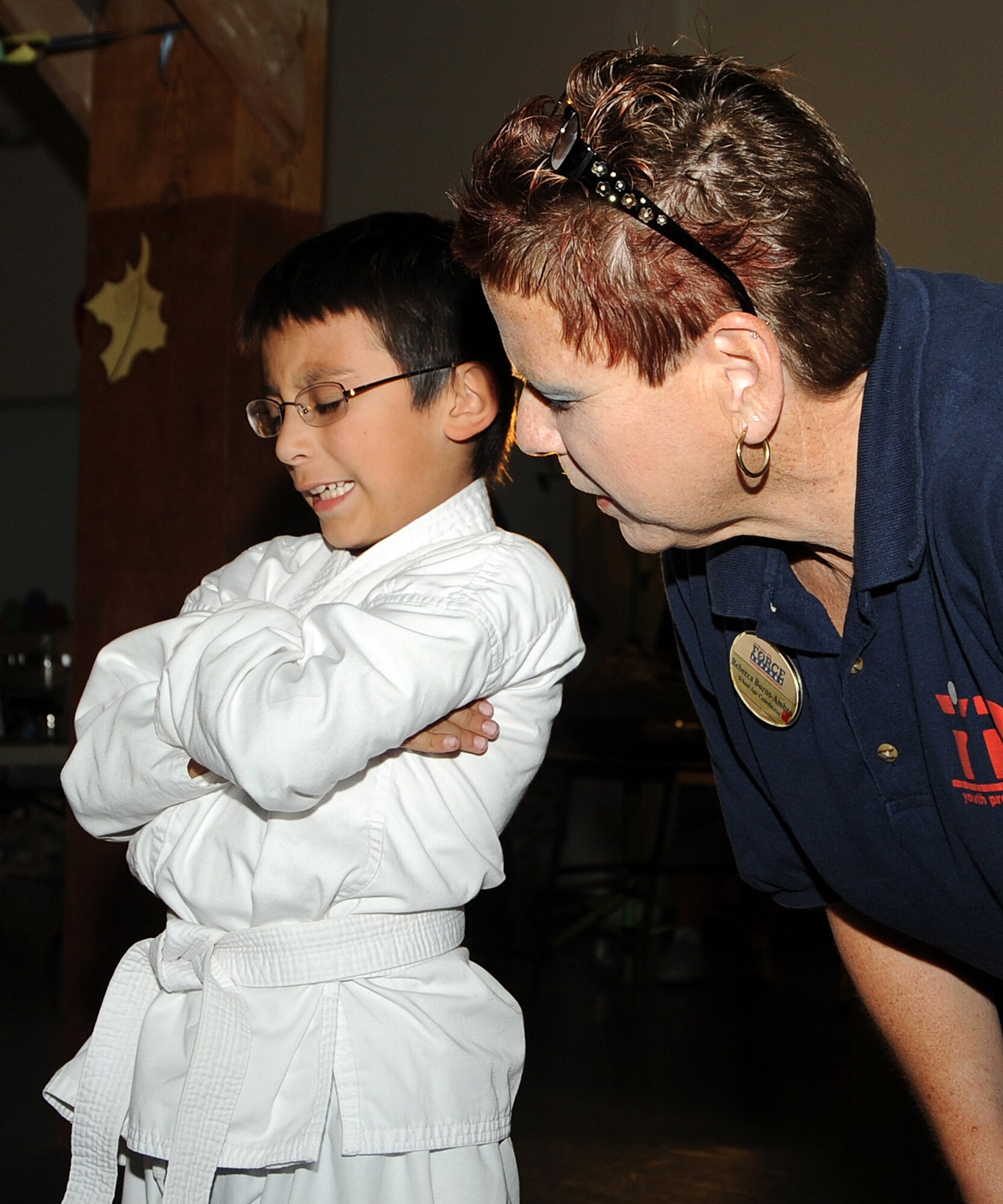 Joseph Mason (left) says Grace before their meal as he “stands in” for the Chaplain during the 8th annual Harvest Fest held at the Fort McArthur Youth Center, San Pedro, Calif., Nov. 19. Children and staff from the Youth Programs prepared food for the celebration and the children demonstrated what they’ve learned through the YP classes. (Photo by Joe Juarez)