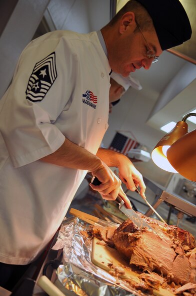 FAIRCHILD AIR FORCE BASE, Wash. – Chief Master Sgt. David Nordel, 92nd Air Refueling Wing command chief, carves roast beef for Thanksgiving Day meals at the Warrior Dining Facility Nov. 26. Chief Nordel was one of 21 first sergeants, chiefs and commanders who volunteered to serve the patrons of Fairchild for this holiday meal. (U.S. Air Force photo / Senior Airman Jocelyn A. Guthrie)