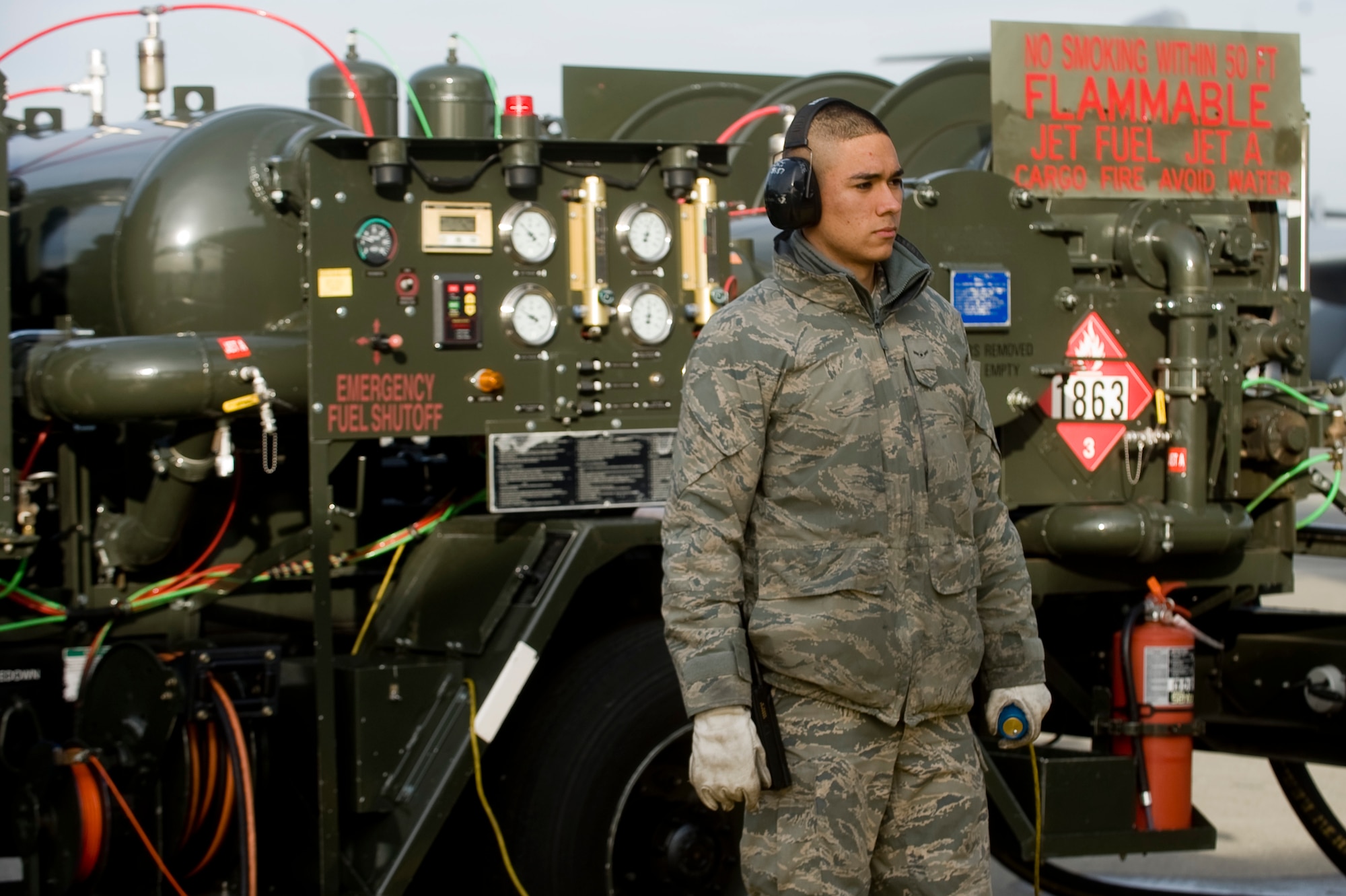 Airman Julio Chavez, a fuels distribution operator assigned to the 62nd Logistics Readiness Squadron here, holds an emergency shut-off switch while refueling a C-17 Globemaster III with Jet A commerical jet fuel on the McChord flightline Thursday. (U.S. Air Force photo/Abner Guzman)