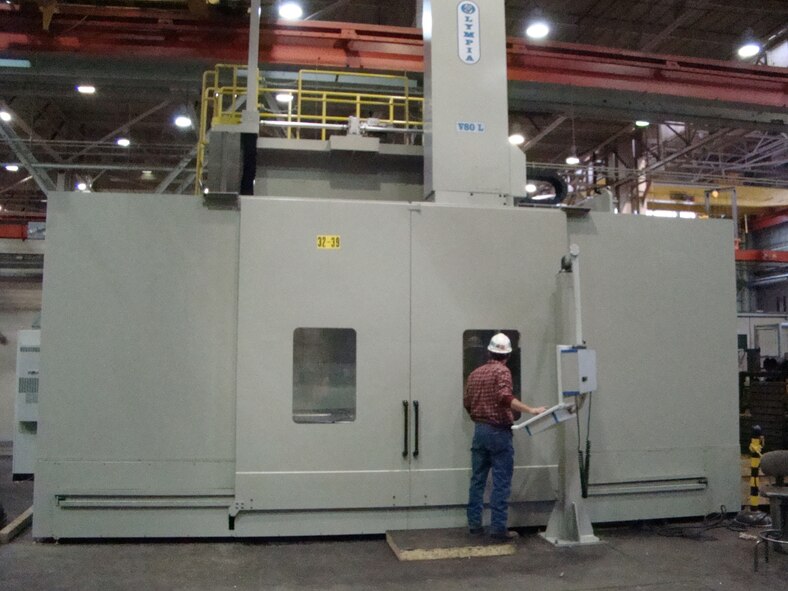 Machinist David Taylor operates the new 80-foot vertical machining center to grind compressor blade assemblies for Plenum Evacuation System. (Photo by Bob Boswell)